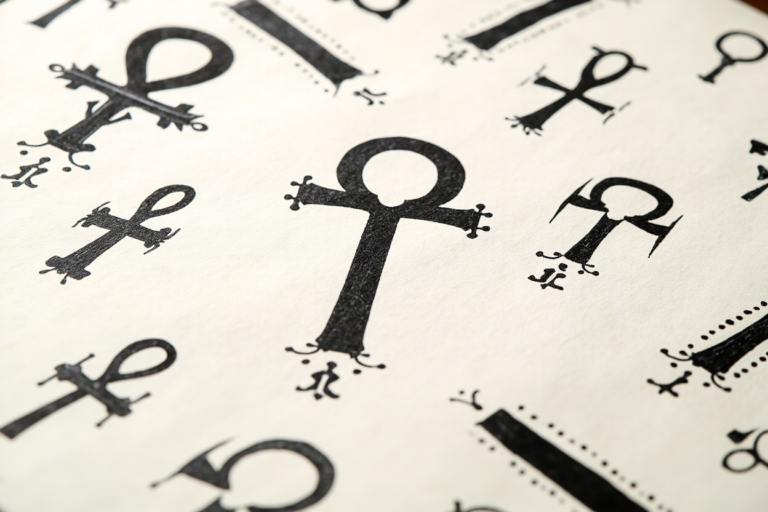 Ankh tattoo flash sheet with Egyptian ankh cross variations in black ink, ornamental and blackwork ankh designs with hieroglyph accents