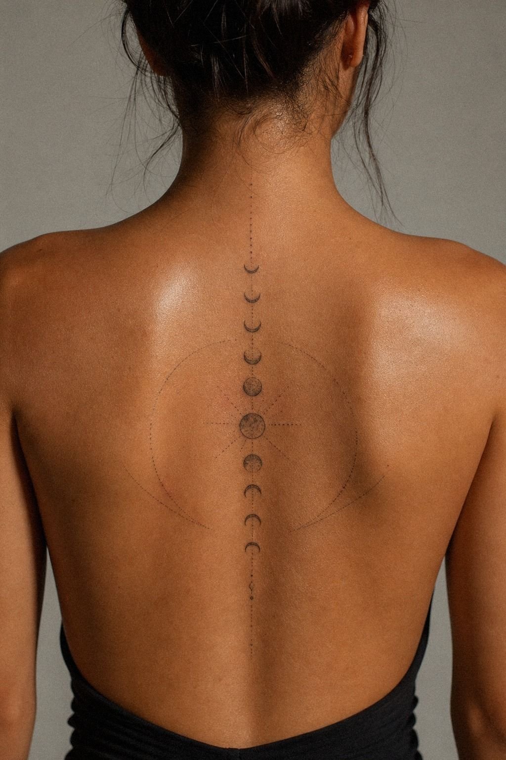Minimal Moon Phase Spine Tattoo