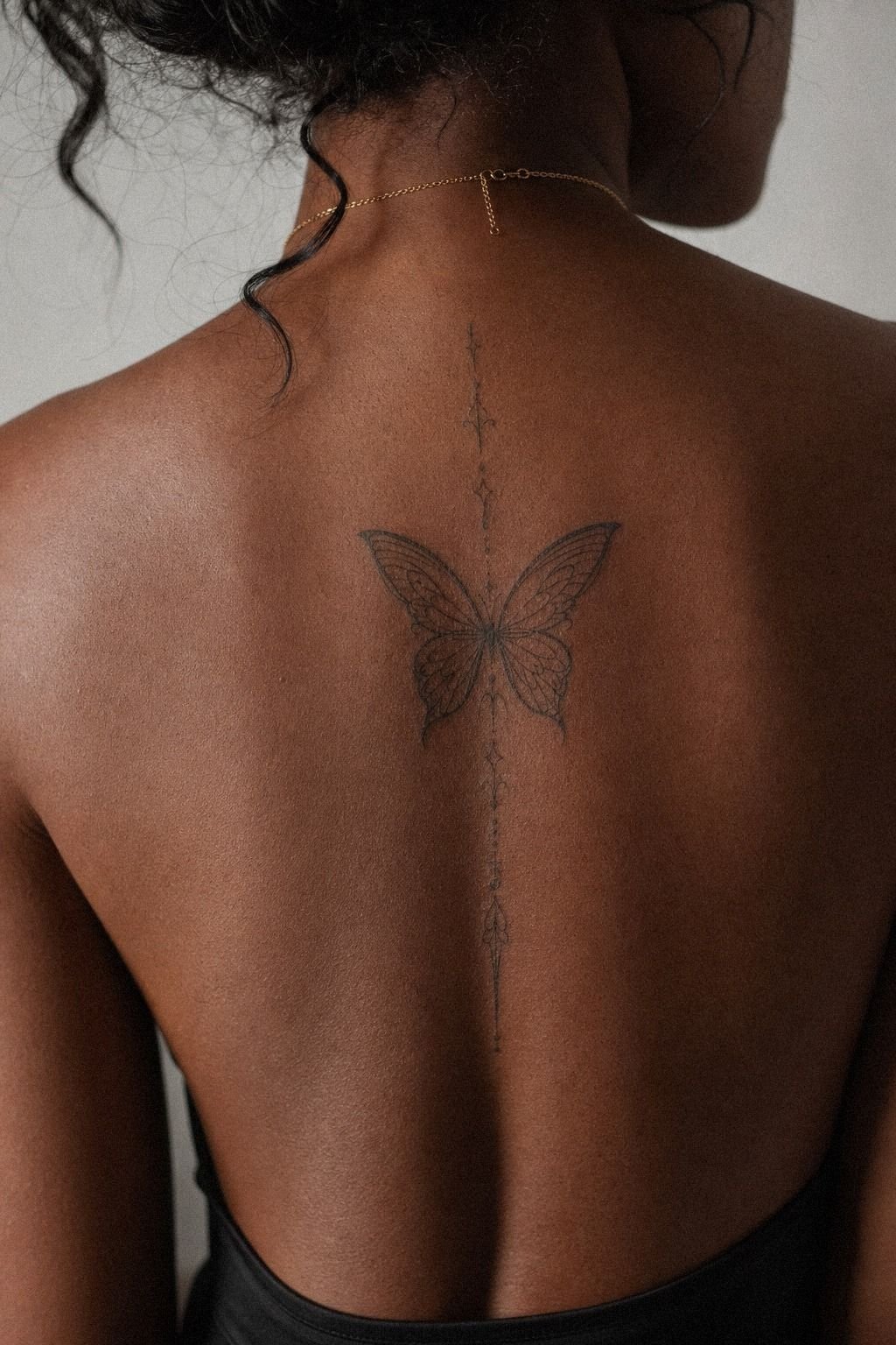 Single Needle Butterfly Spine Tattoo
