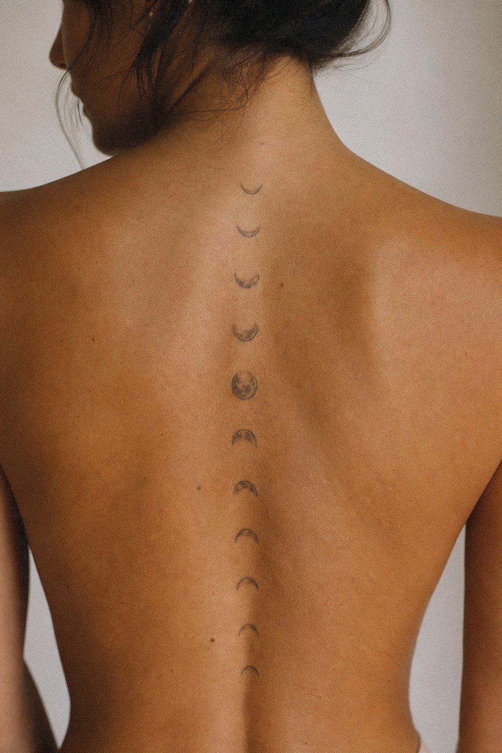 Place A Moon Phase Spine Tattoo