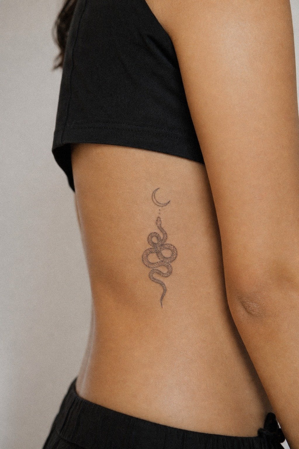 Place A Snake And Moon Rib Tattoo