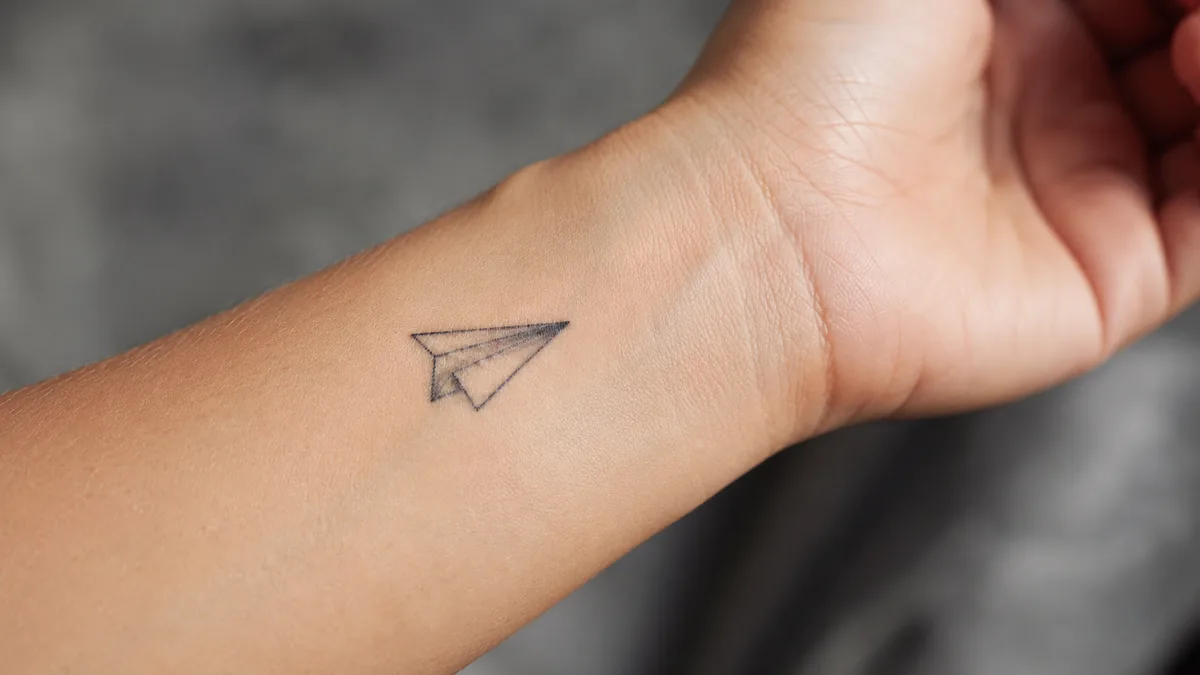 Paper Plane Tattoo - Placement, Pain, and How It Ages