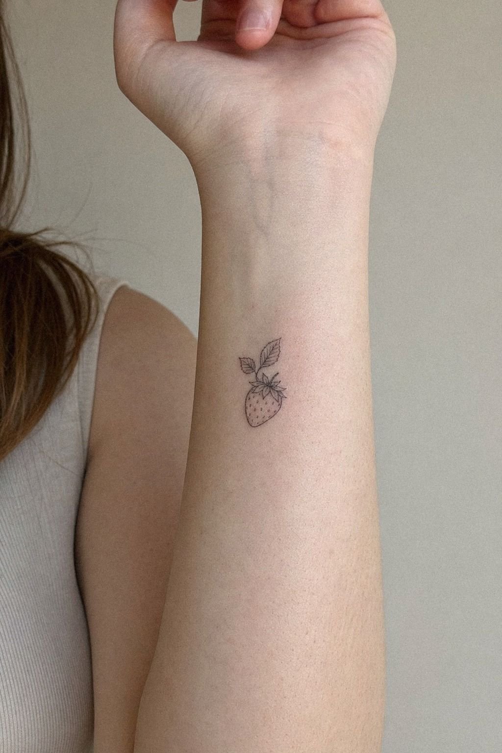 Fine Line Strawberry Wrist Tattoo