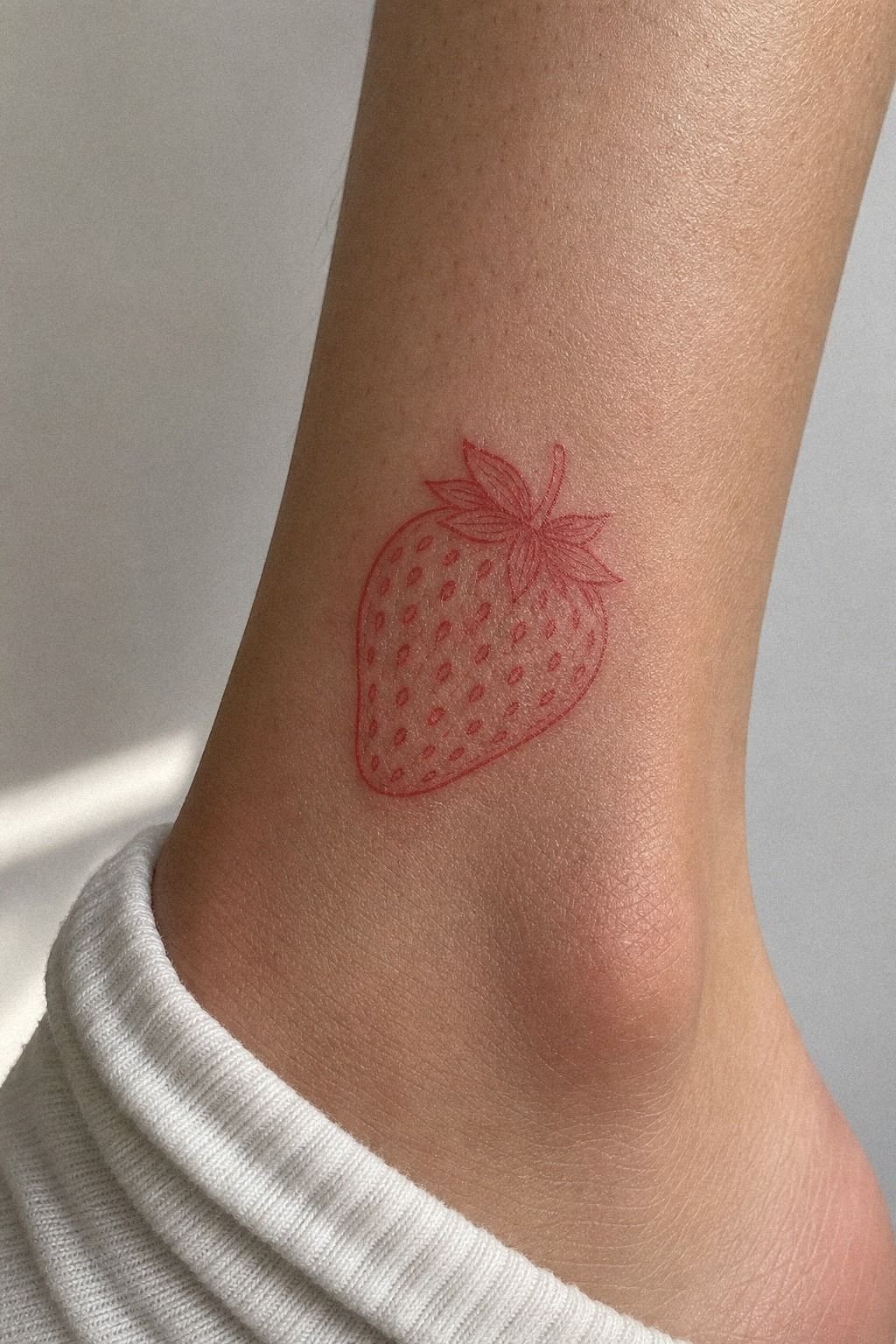 Tiny Red Ink Strawberry Ankle Tattoo
