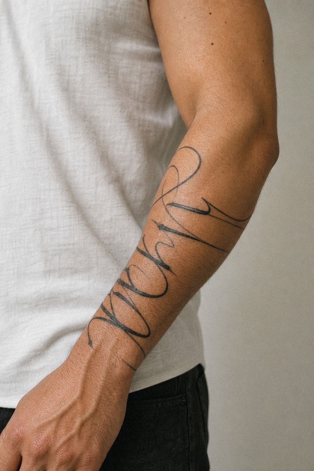 Last Name Script Forearm Tattoo