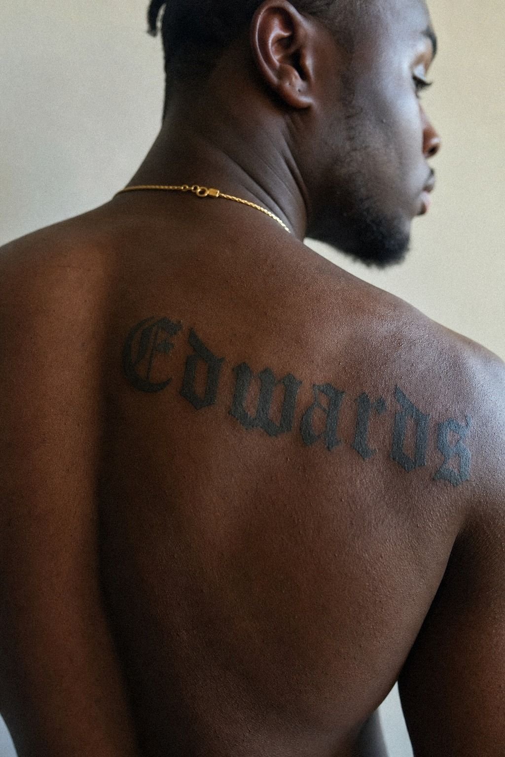 Bold Last Name Shoulder Tattoo