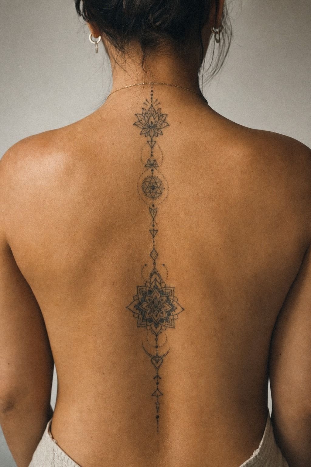 Ornamental Mandala Spine Tattoo