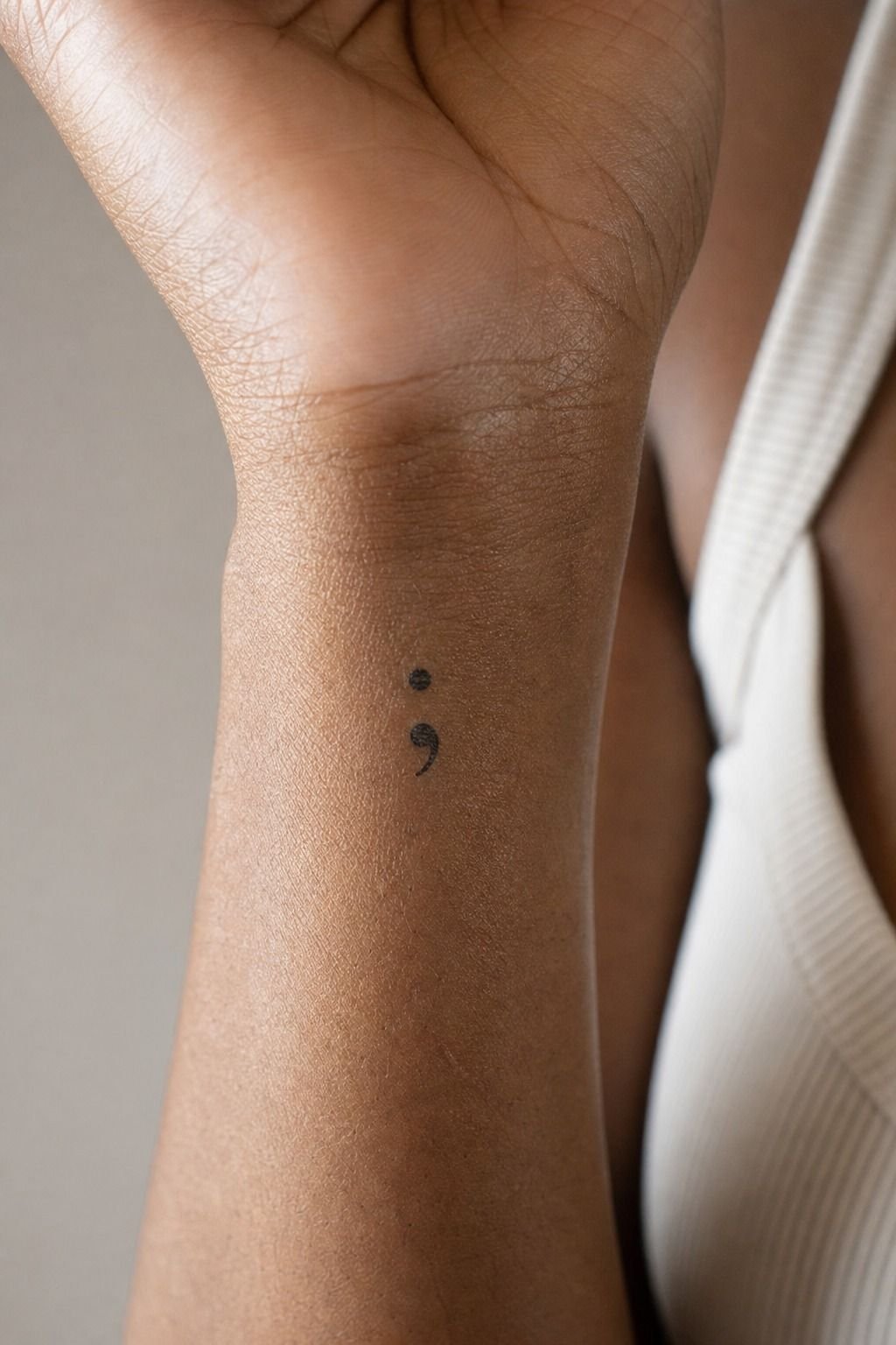 Mark a small semicolon on the inner wrist