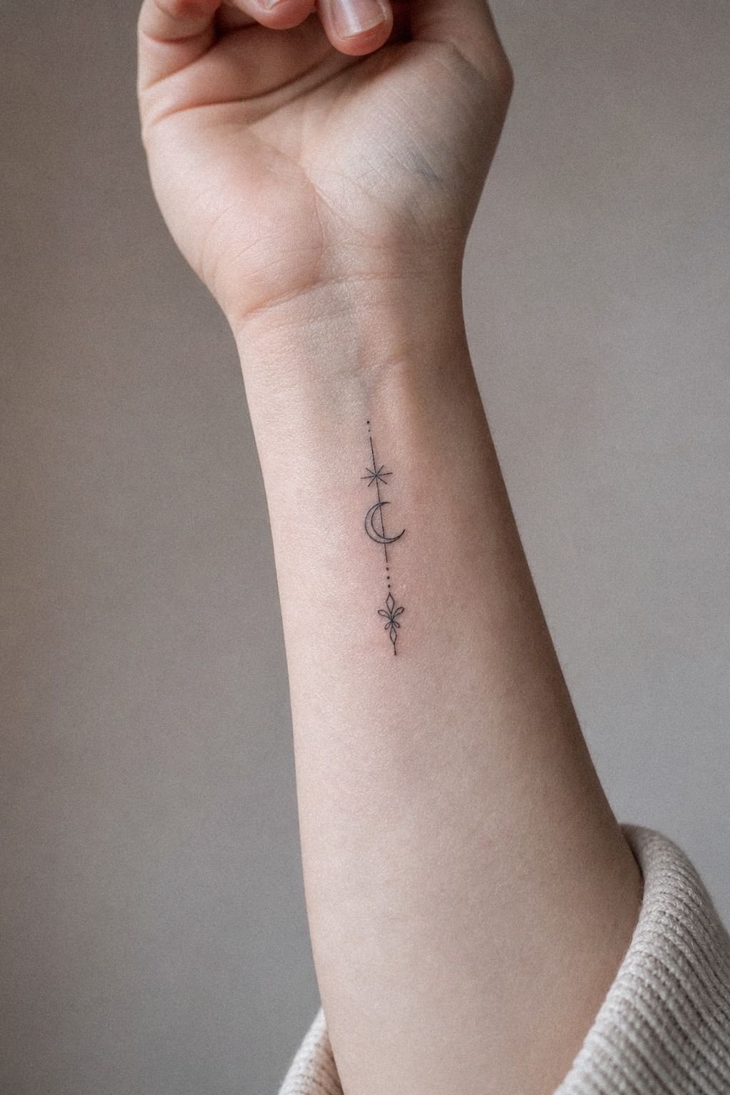 Fine Line Symbolic Tattoo On The Wrist