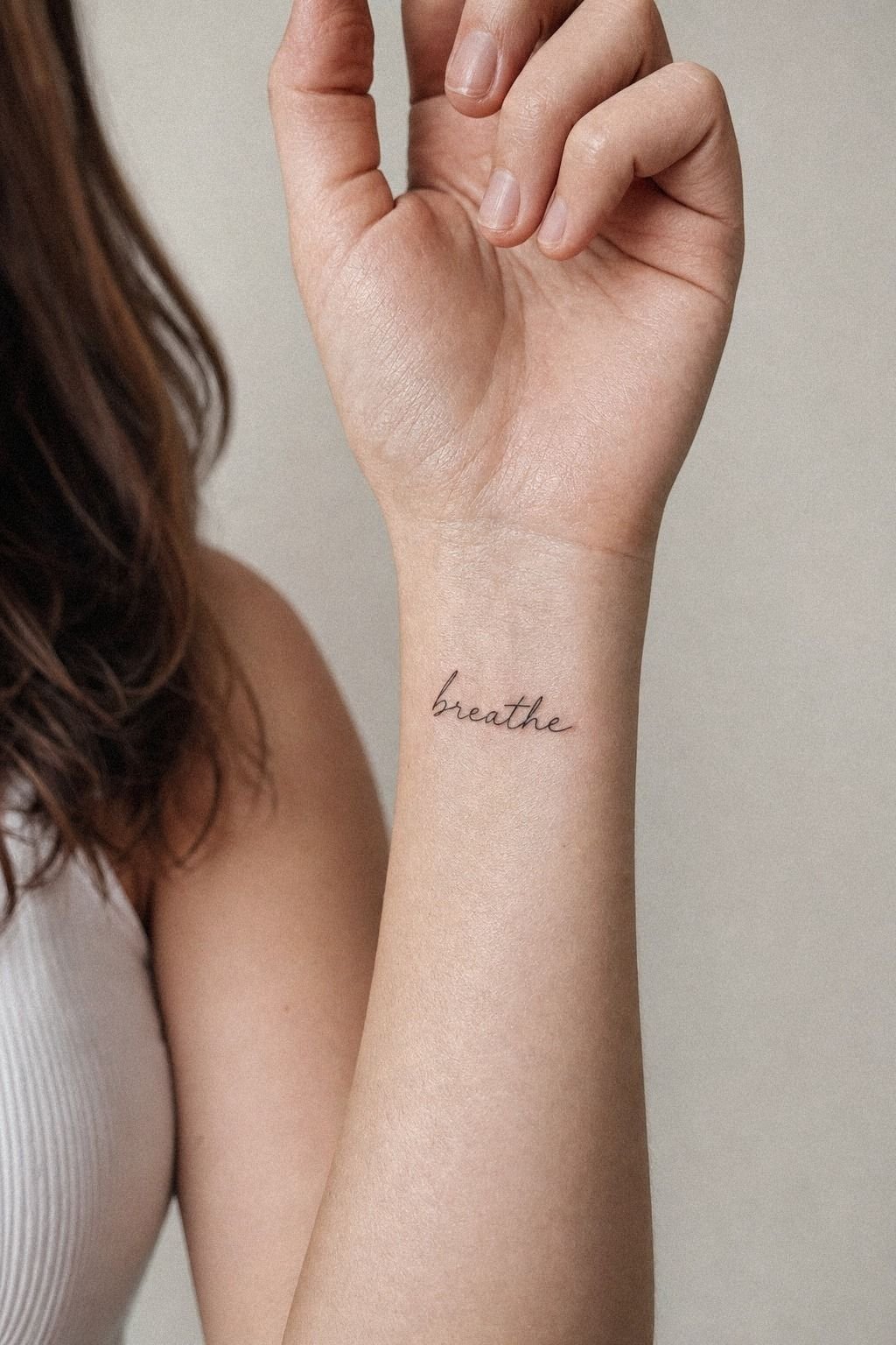 Fine Line Word Tattoo On The Wrist
