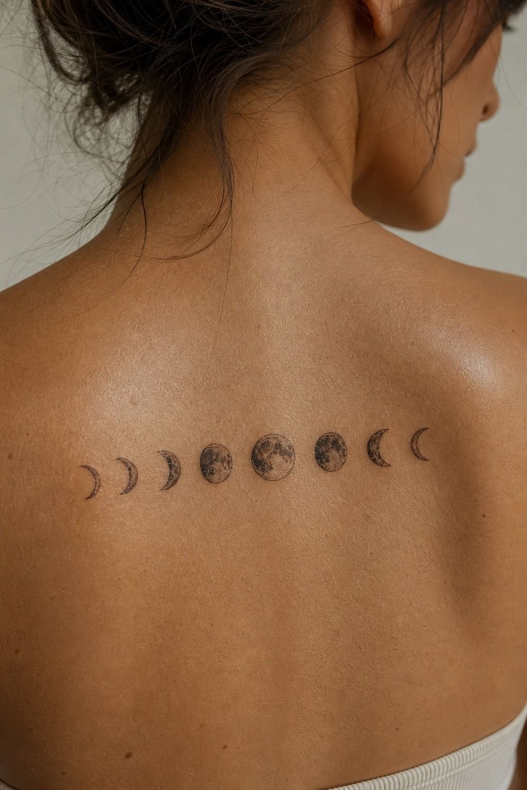 Tiny Moon Phase Upper Back Tattoo