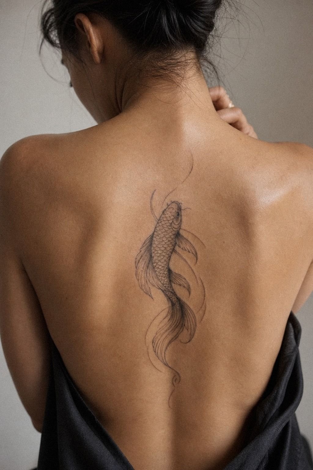 Let a Koi Fish Tattoo Sweep Across the Upper Back