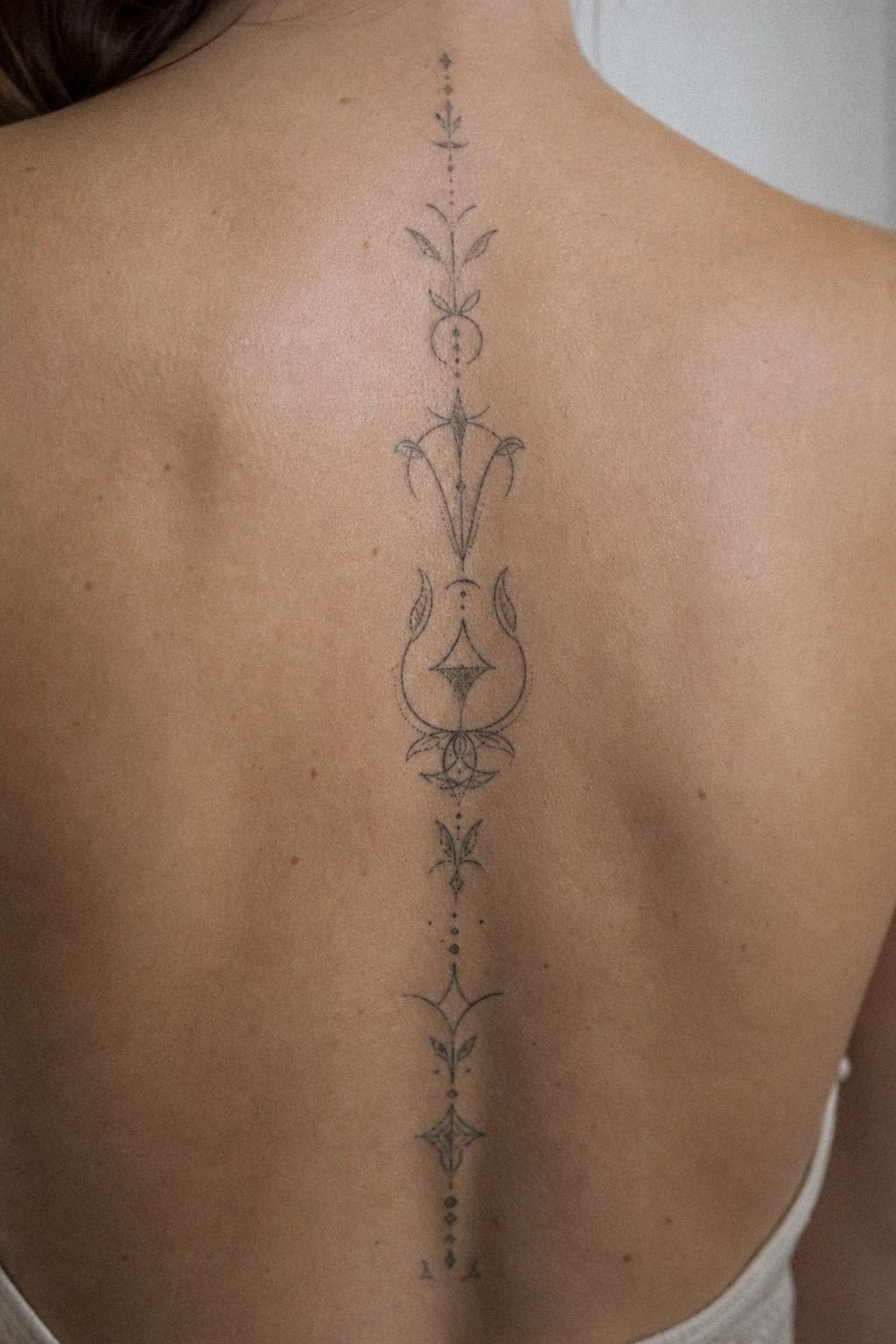 Vertical Spine Word Tattoo With Clean Lettering