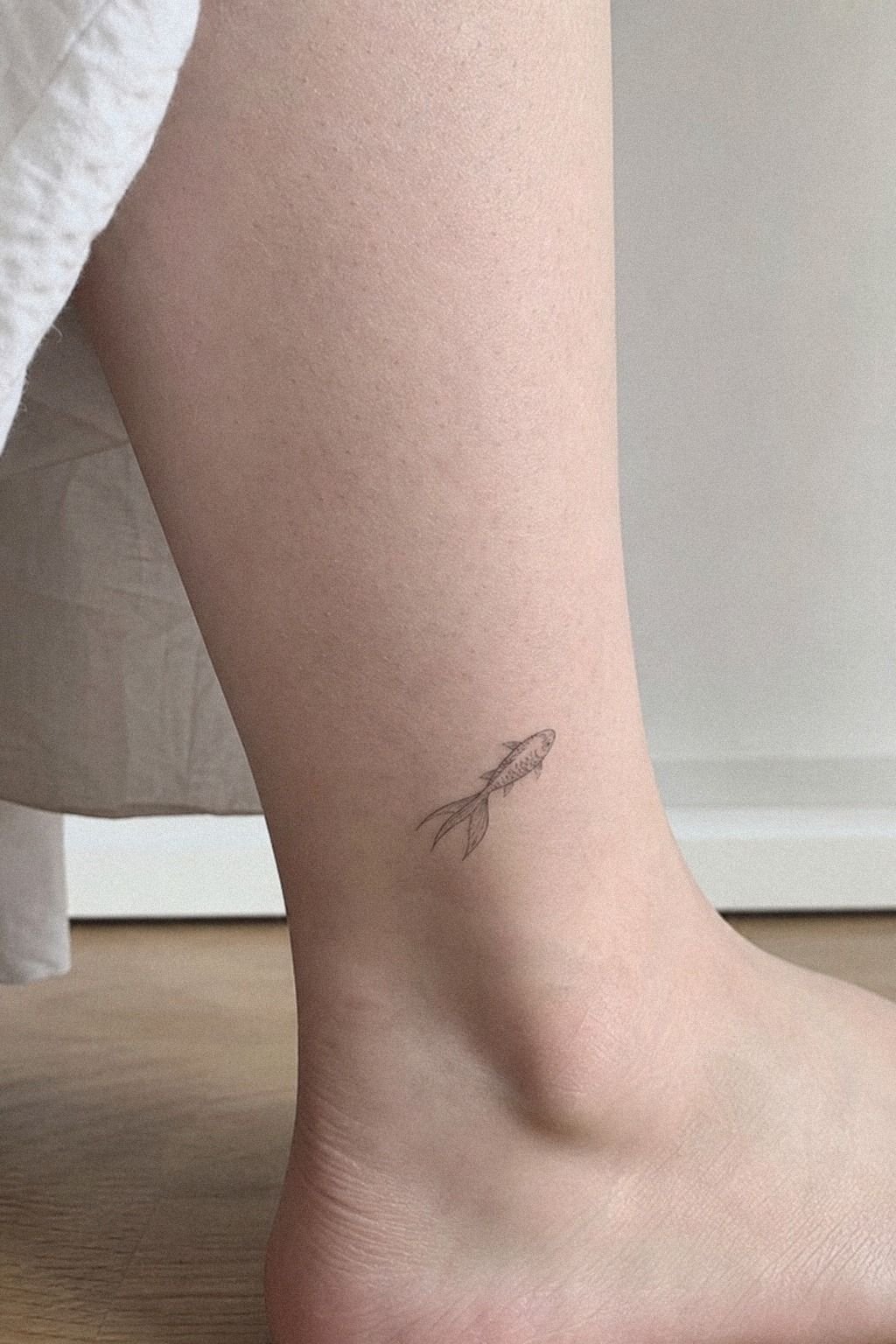 Minimal Fish Tattoo Near The Ankle