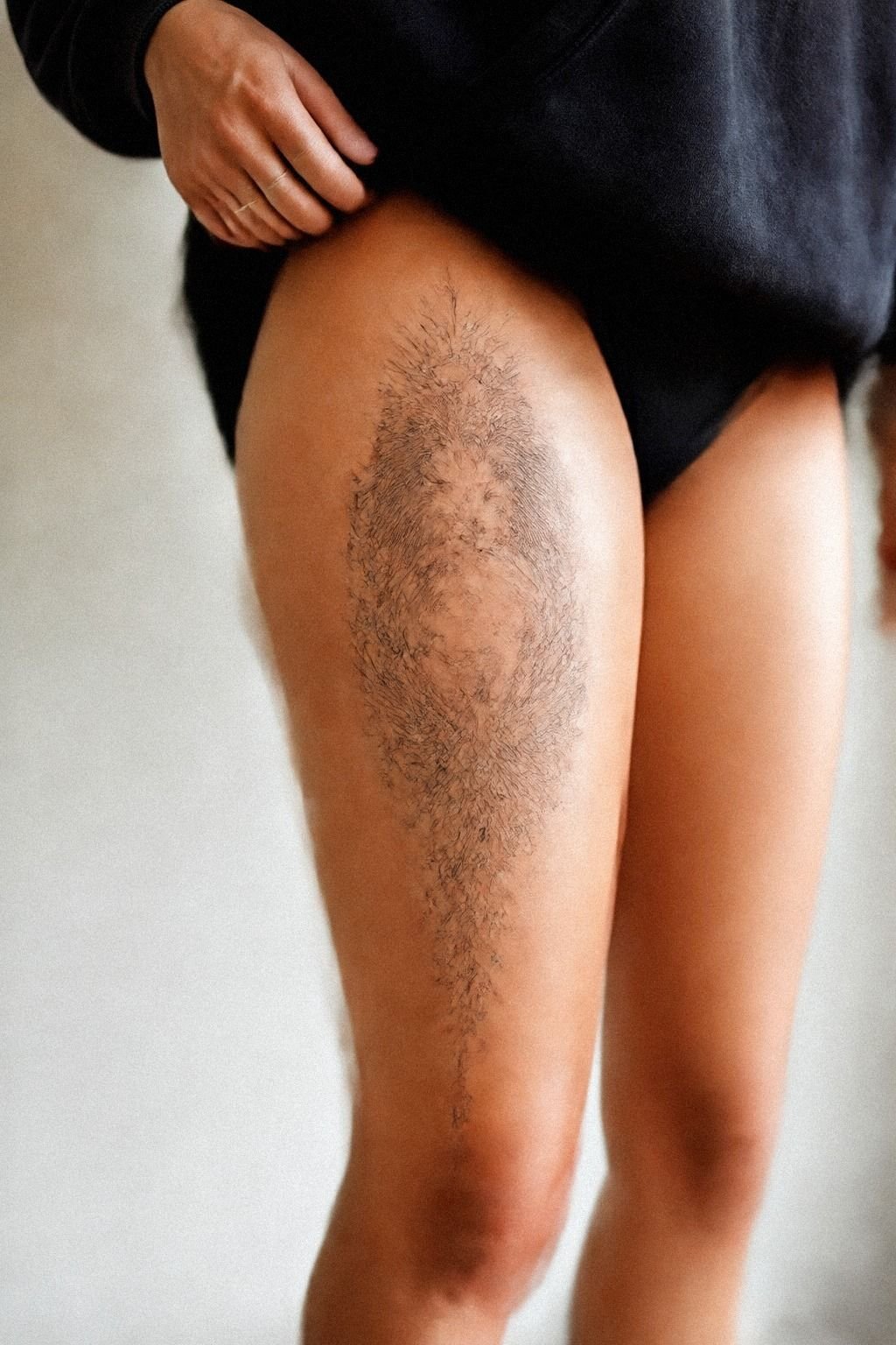 Script Above Knee Tattoo Along Thigh