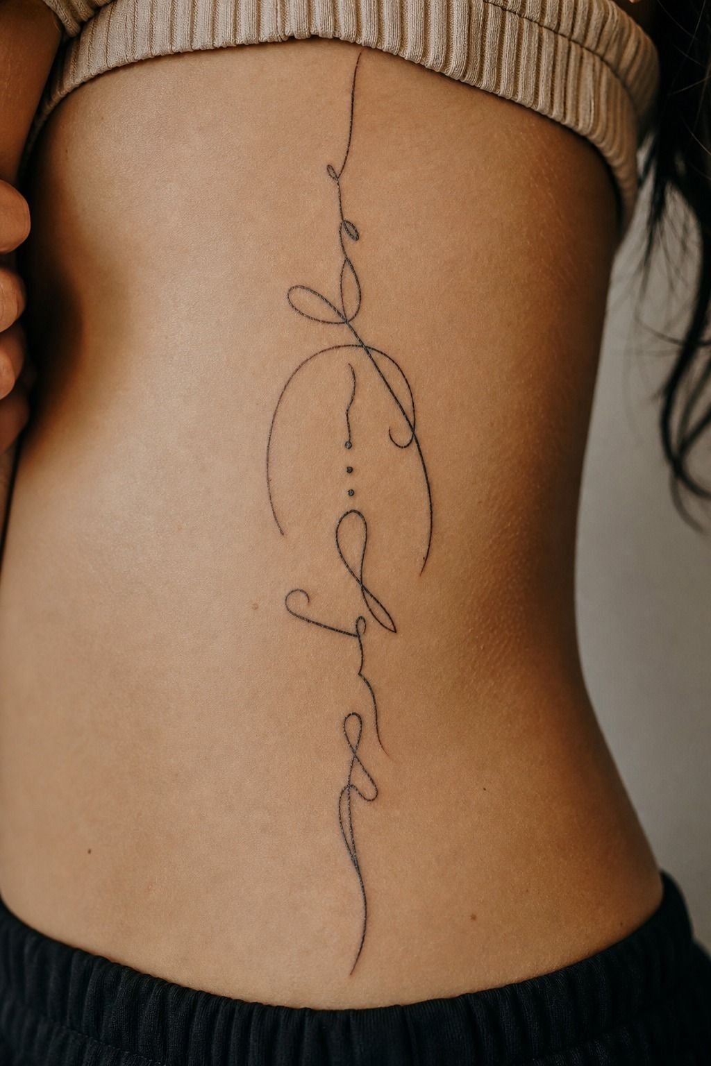 Tuck a Script Spine Tattoo Into the Waist