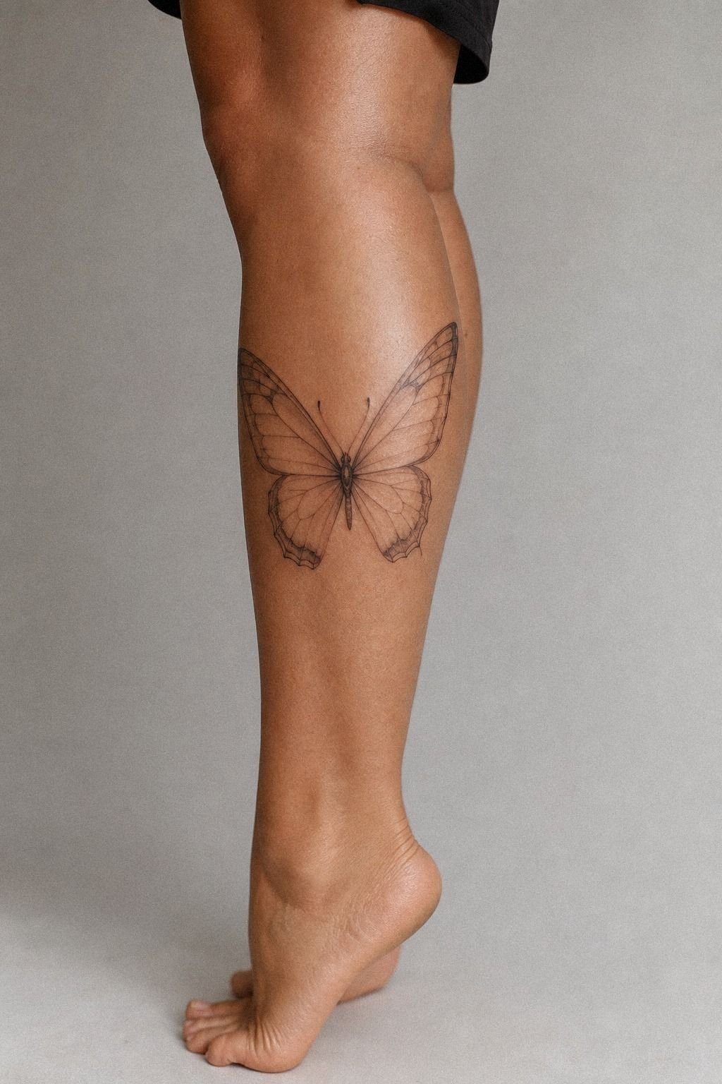 Delicate Butterfly Calf Tattoo With Soft Shading