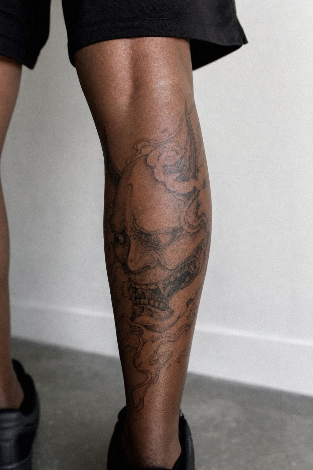 Black And Grey Oni Tattoo On Calf