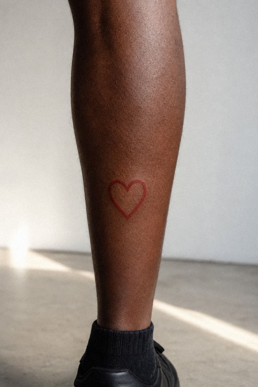 Red Ink Heart Tattoo Near the Calf