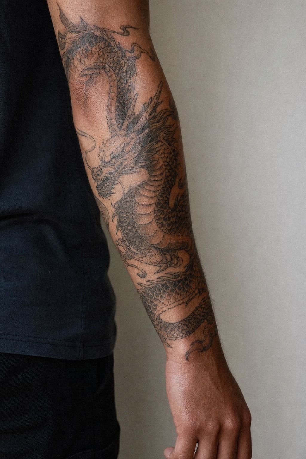 Black And Grey Dragon Forearm Tattoo
