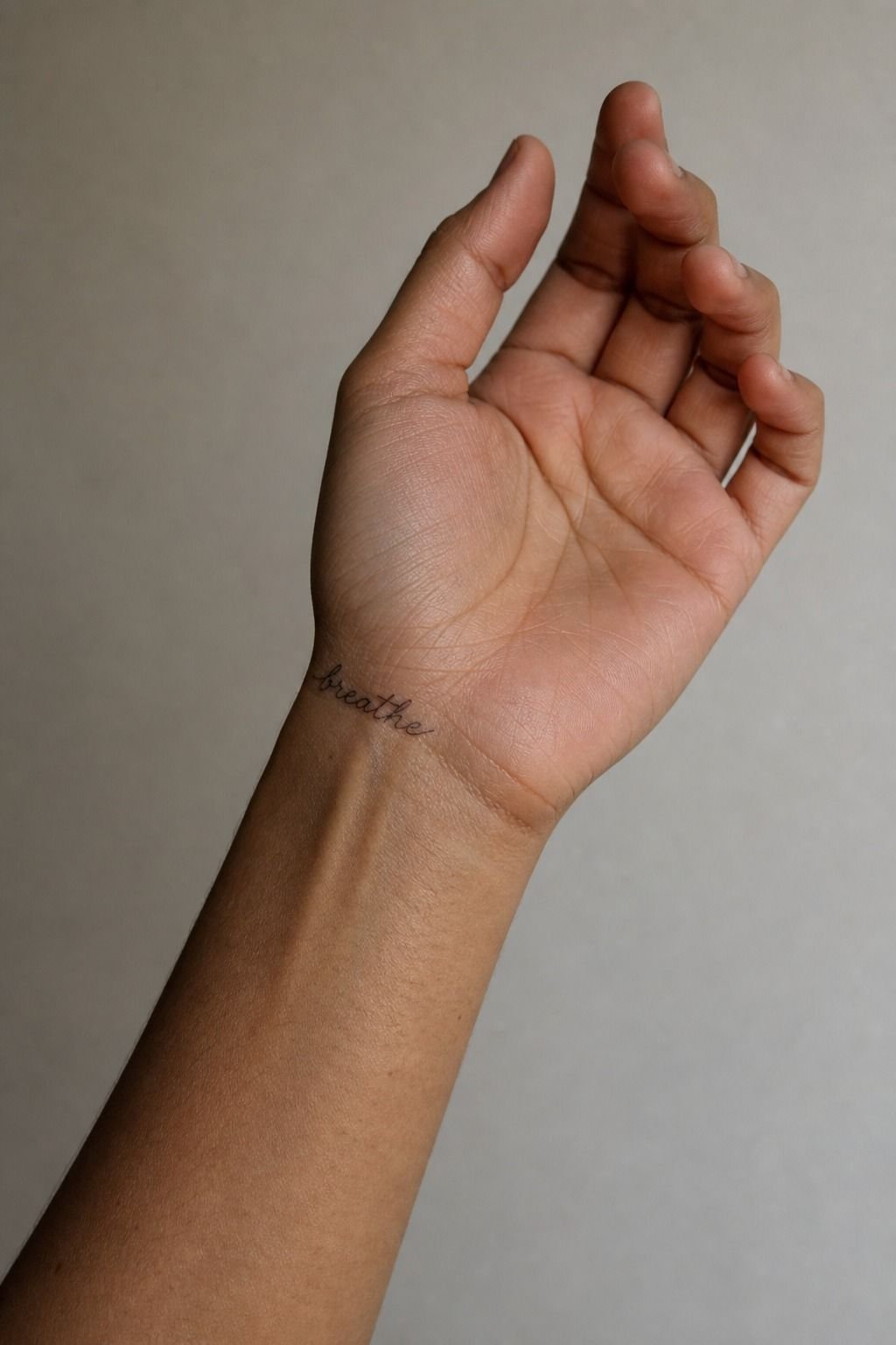Place a single-word script where the thumb meets the palm