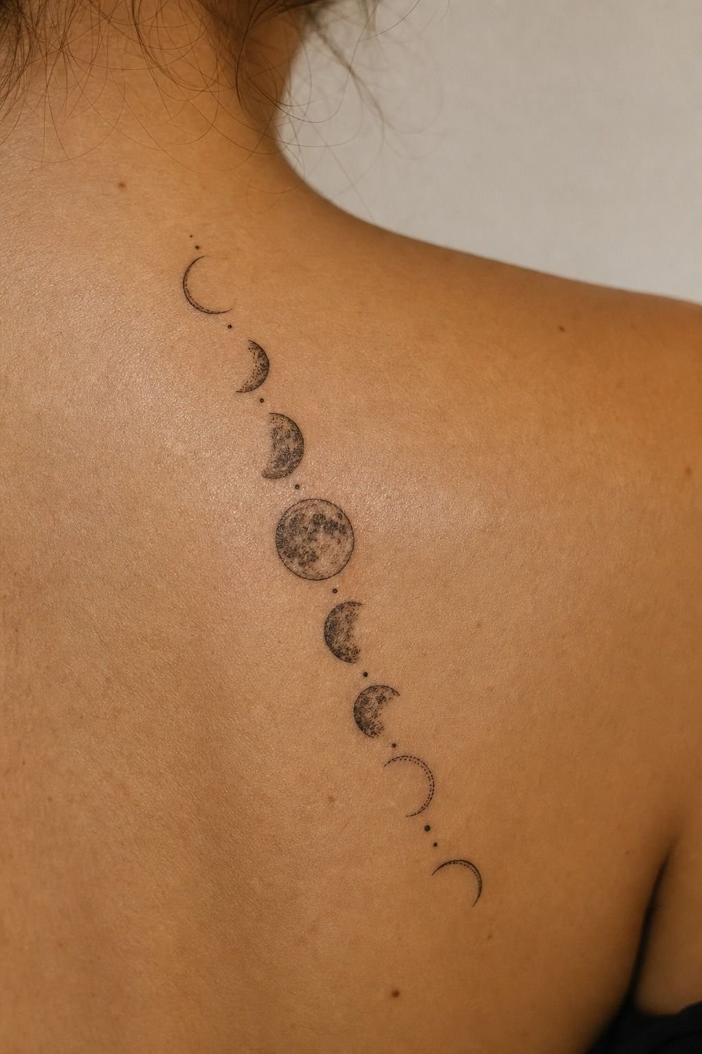 Delicate Moon Phases Along One Shoulder Blade