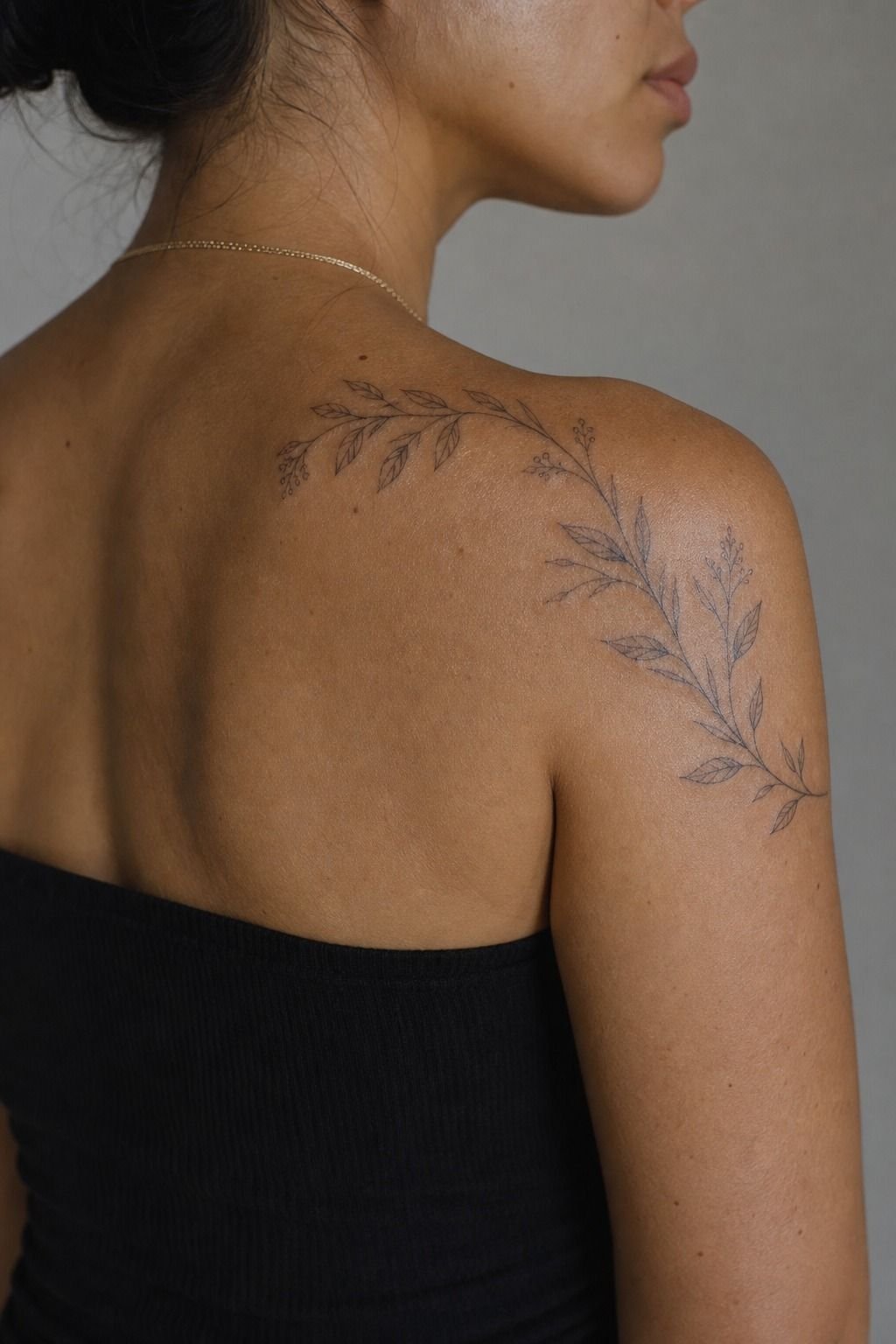 Botanical Shoulder Tattoo Framing the Upper Back