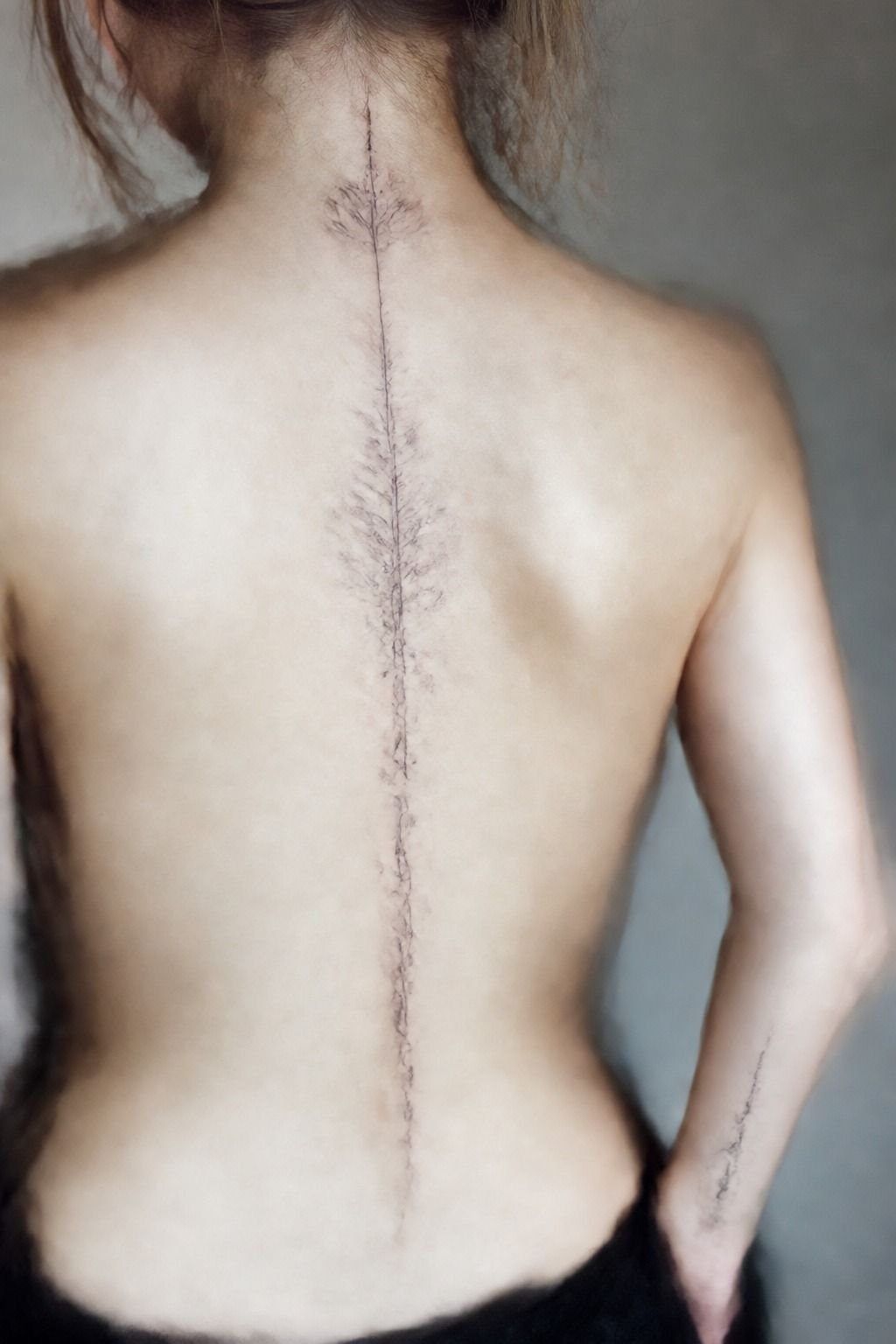 Pairing the spine tattoo with a wrist companion