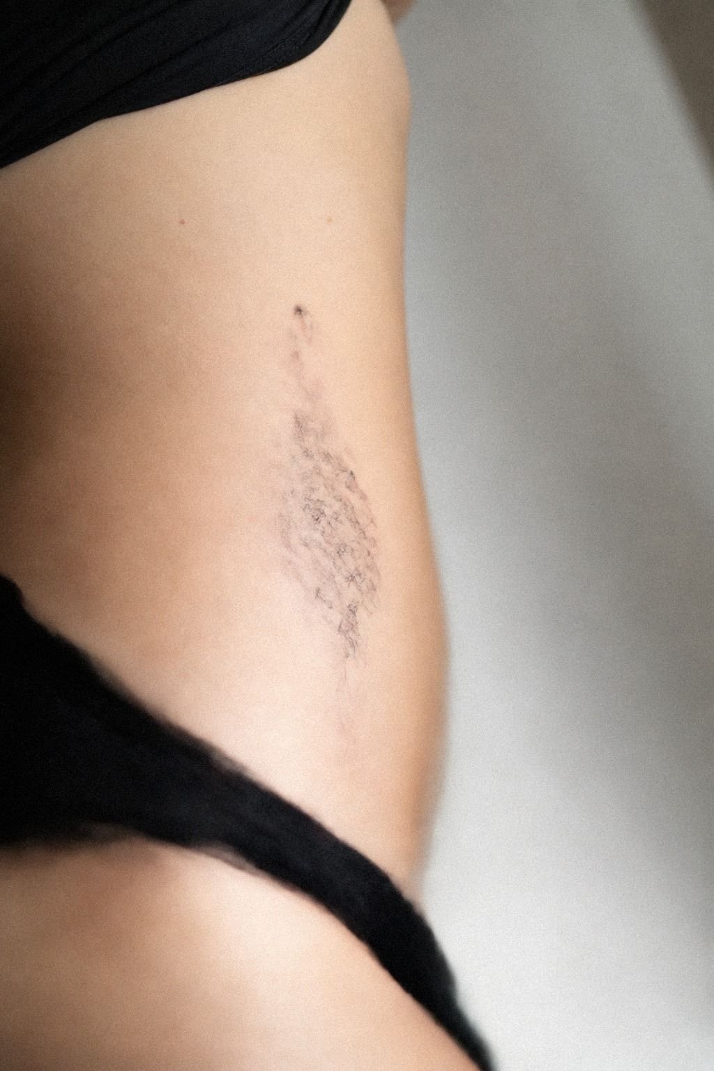 Fine Line Hip Tattoo With Sharp Curves