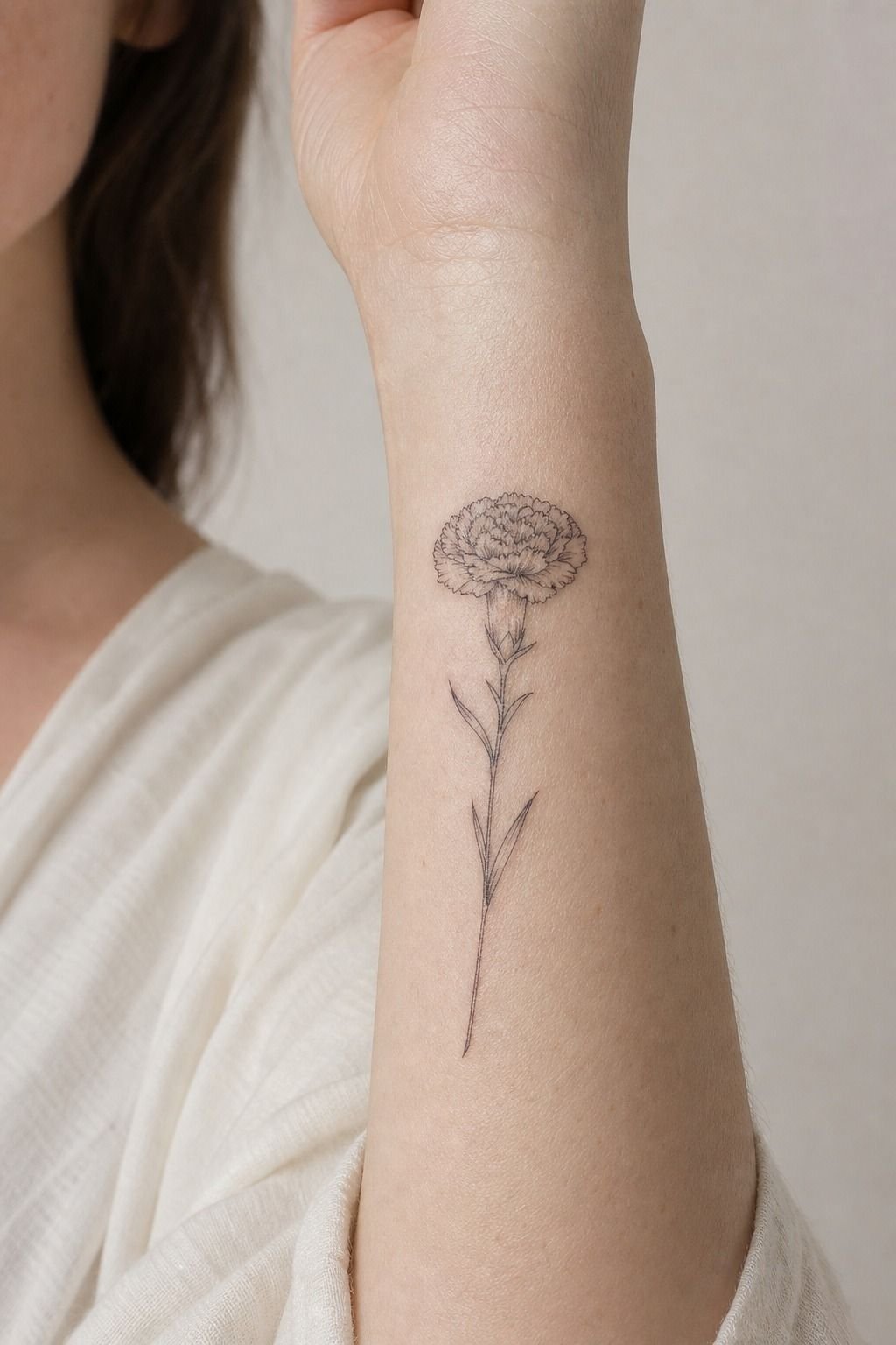 January Carnation Fine-Line Wrist Tattoo