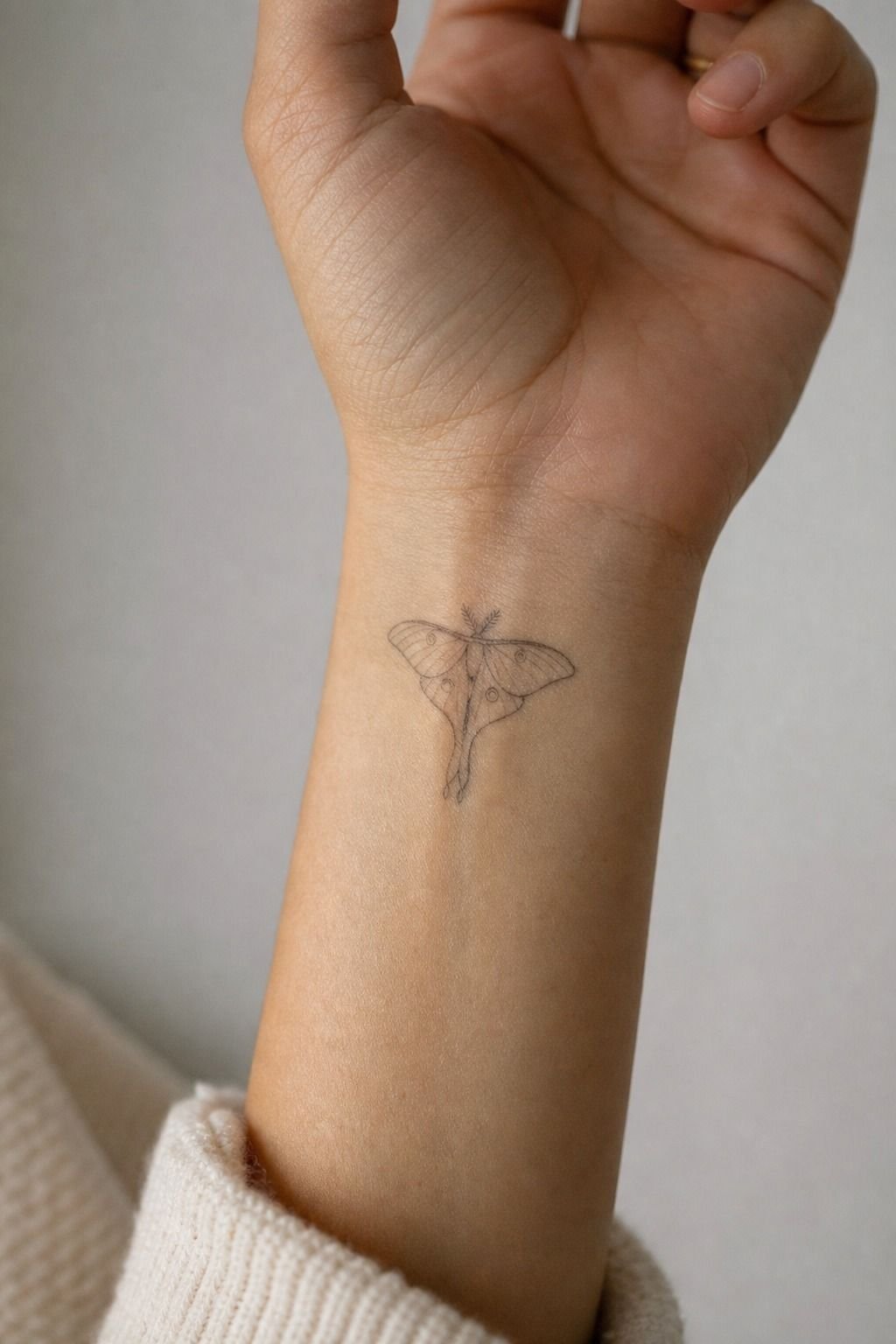 Small Lunar Moth Wrist Tattoo