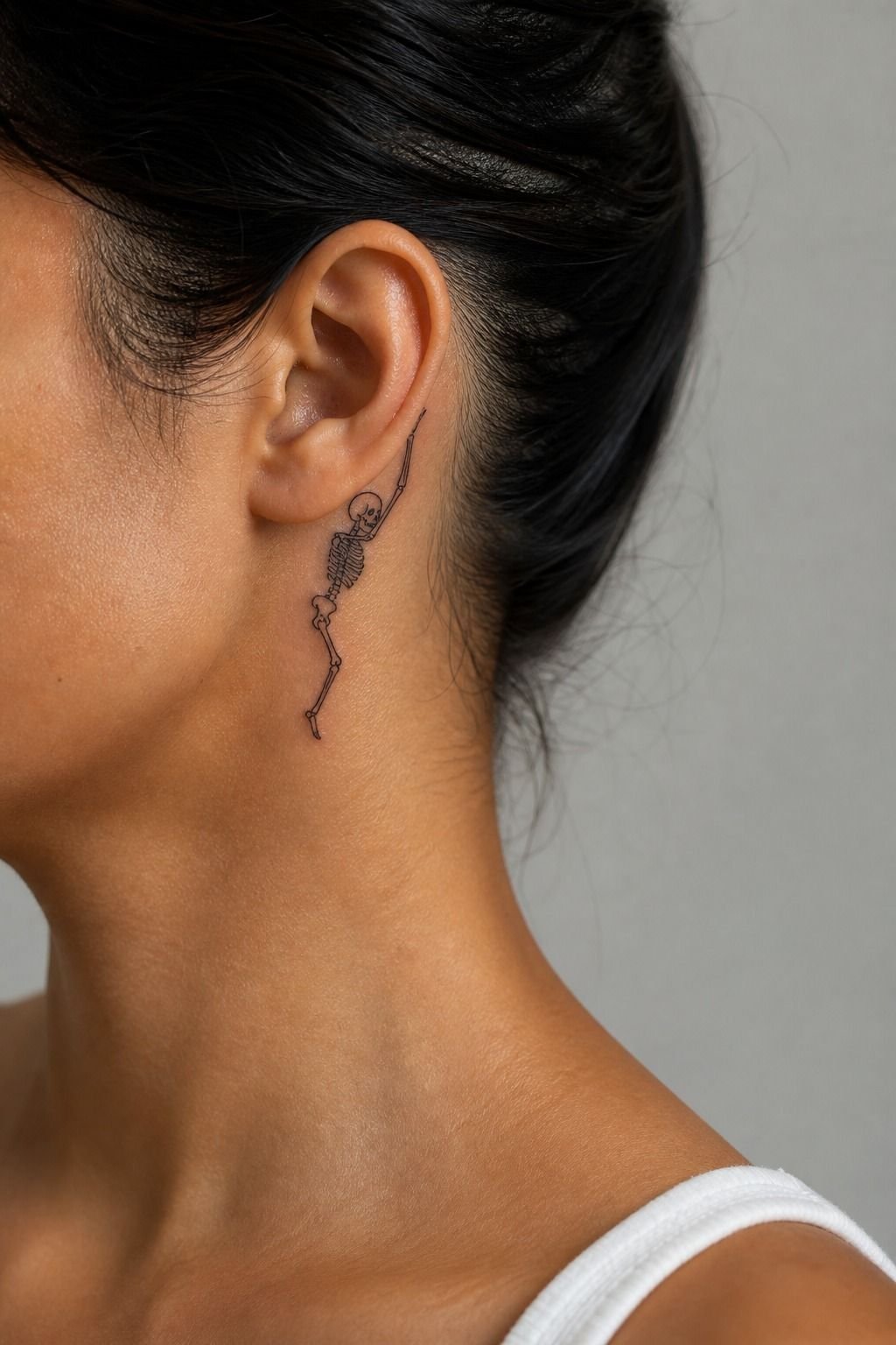 Tiny Skeleton Tattoo Behind The Ear