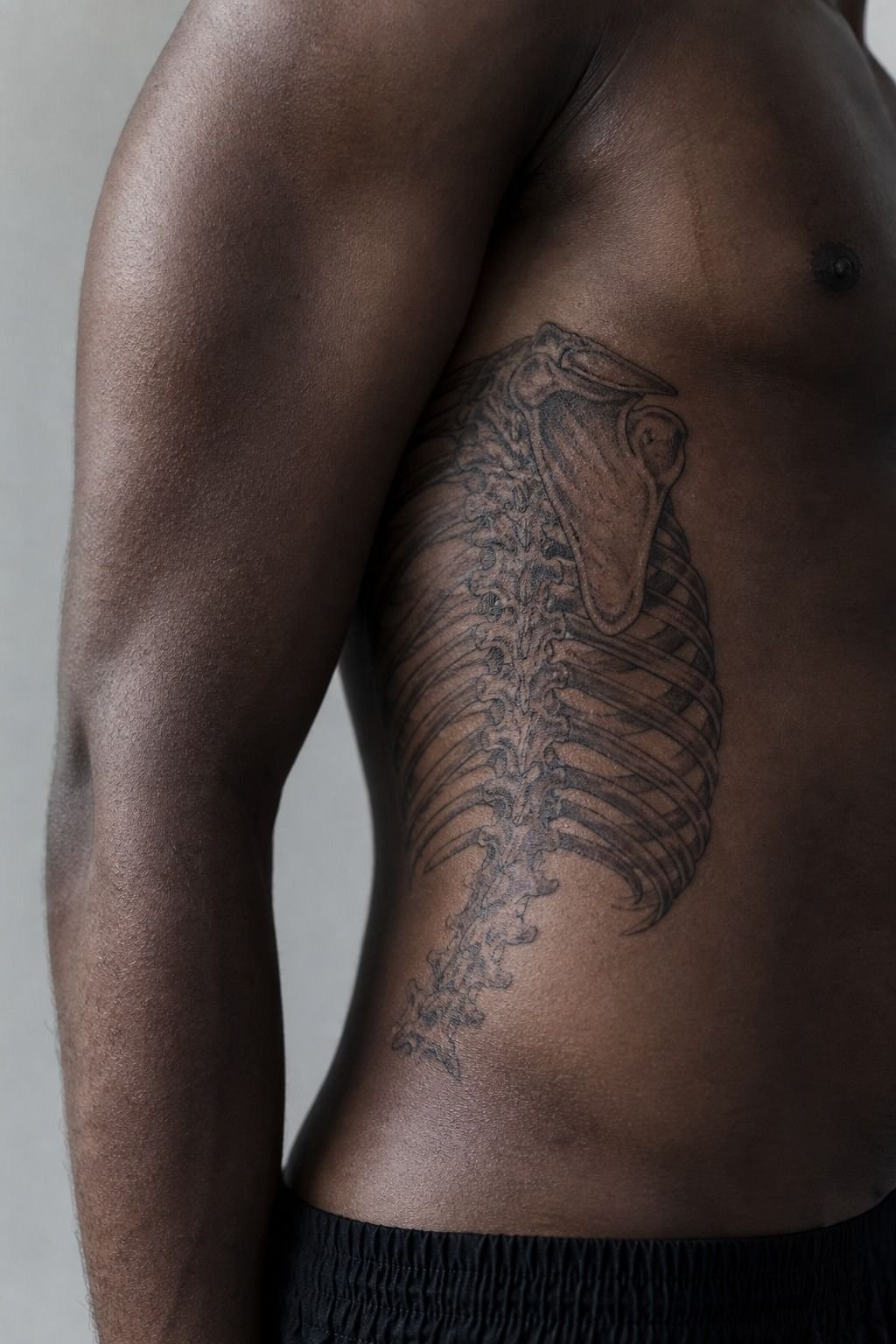 Black And Grey Skeleton Rib Tattoo