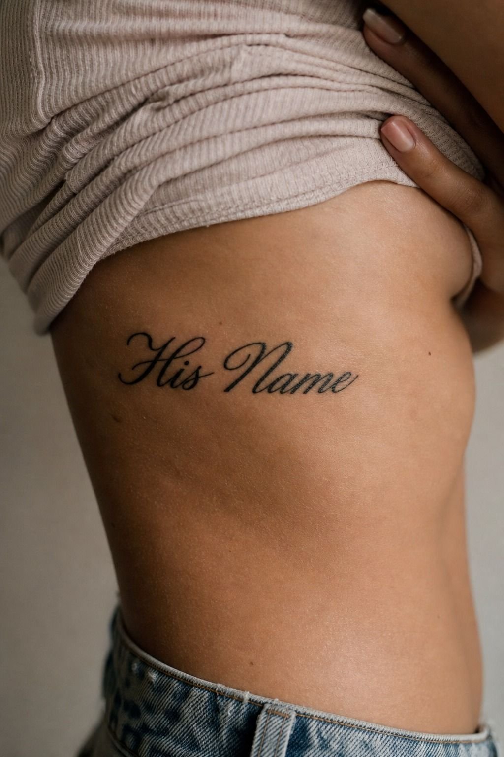 His Name Tattoo Across the Ribcage