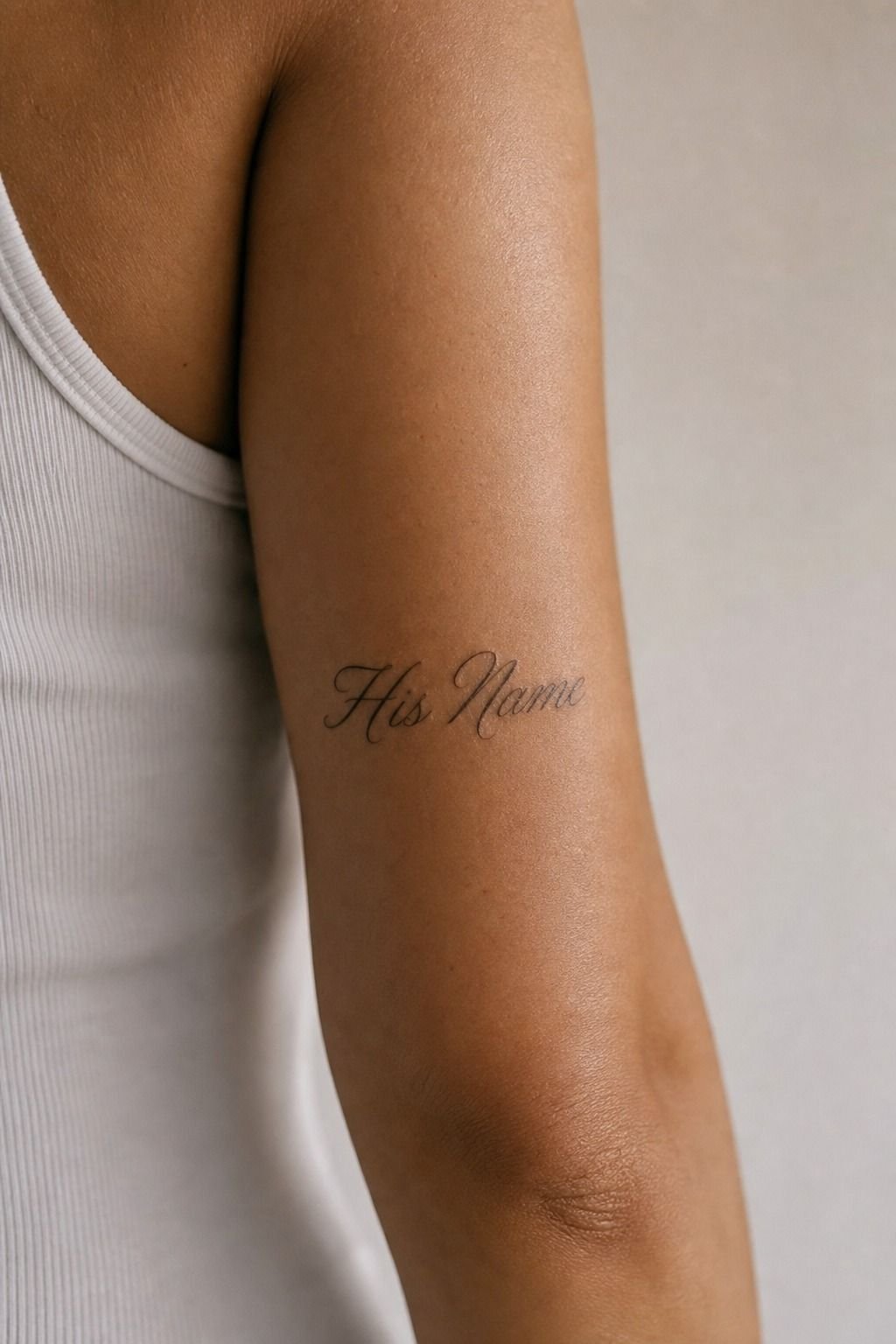 His Name Tattoo Behind the Upper Arm
