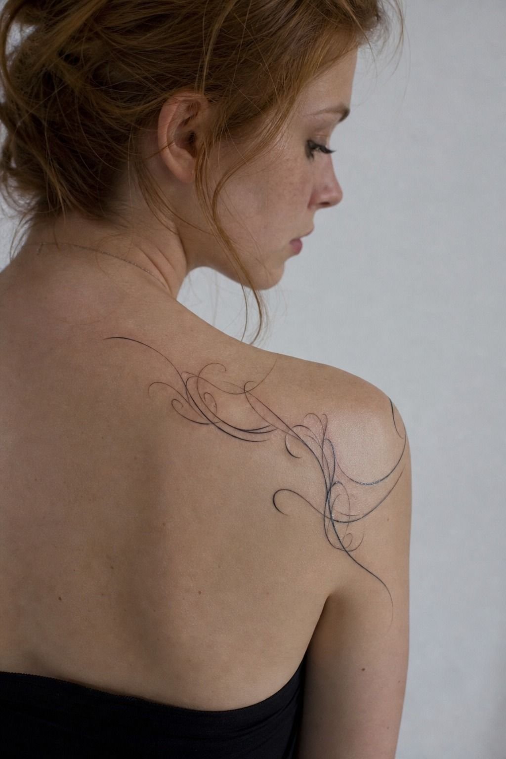 His Name Tattoo Across the Shoulder Blade