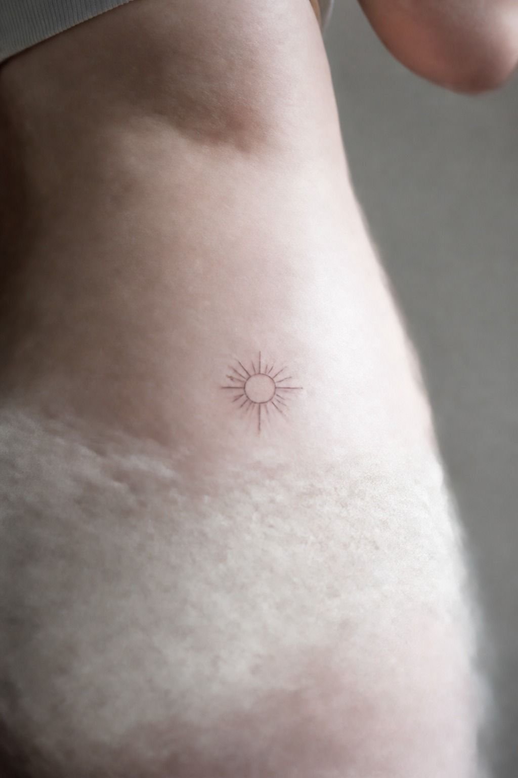Minimalist Sun Hip Tattoos