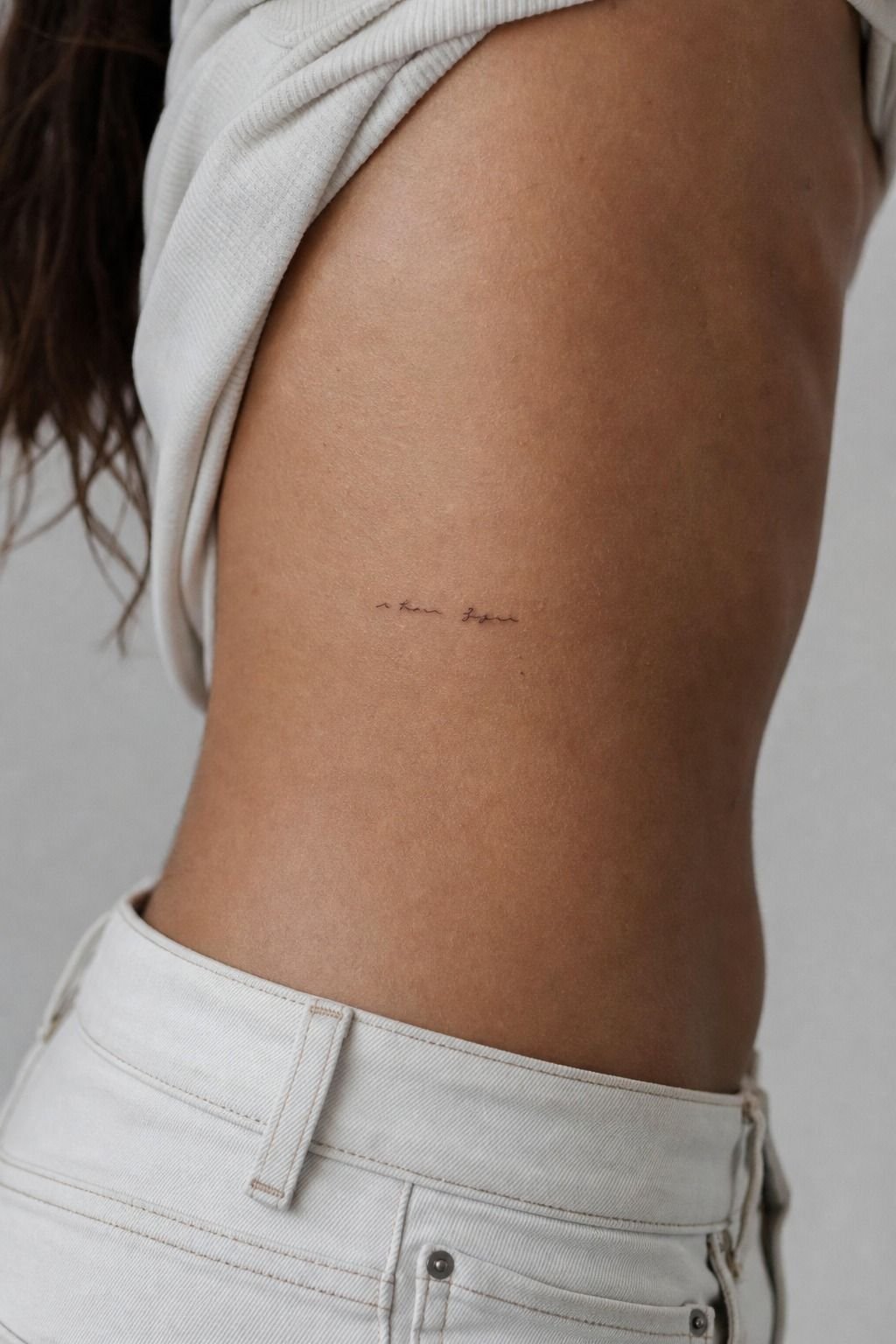 Tiny Handwritten Phrase Near the Hip