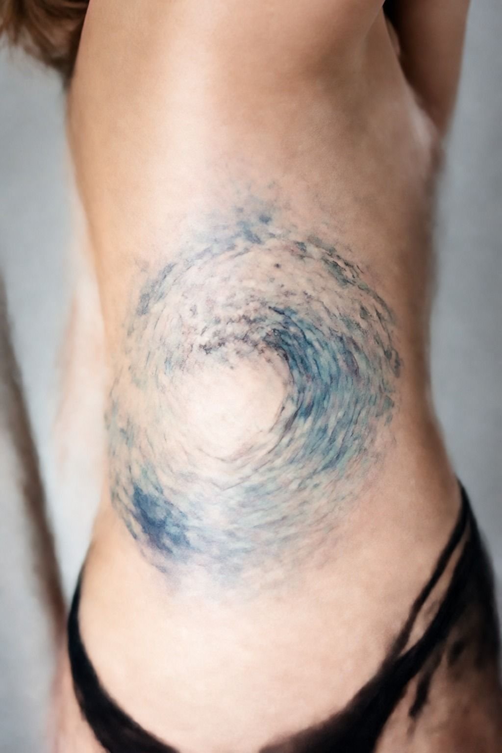 Watercolor Ocean Wave Rib Tattoo