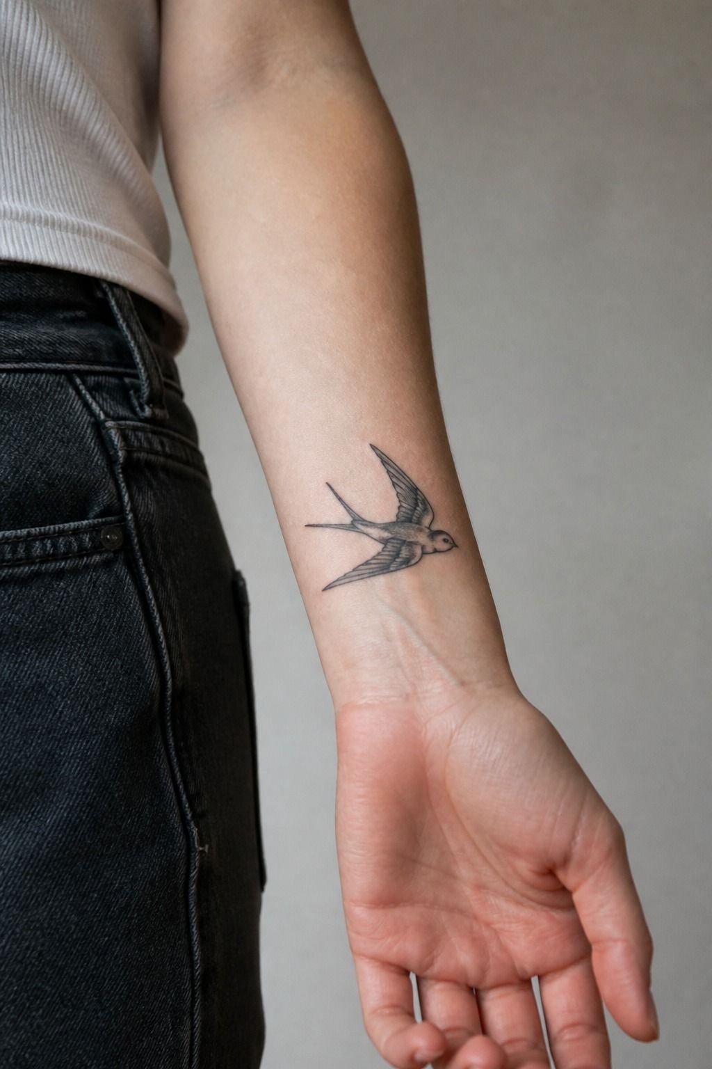 Fine-Line Traditional Swallow Wrist Tattoo