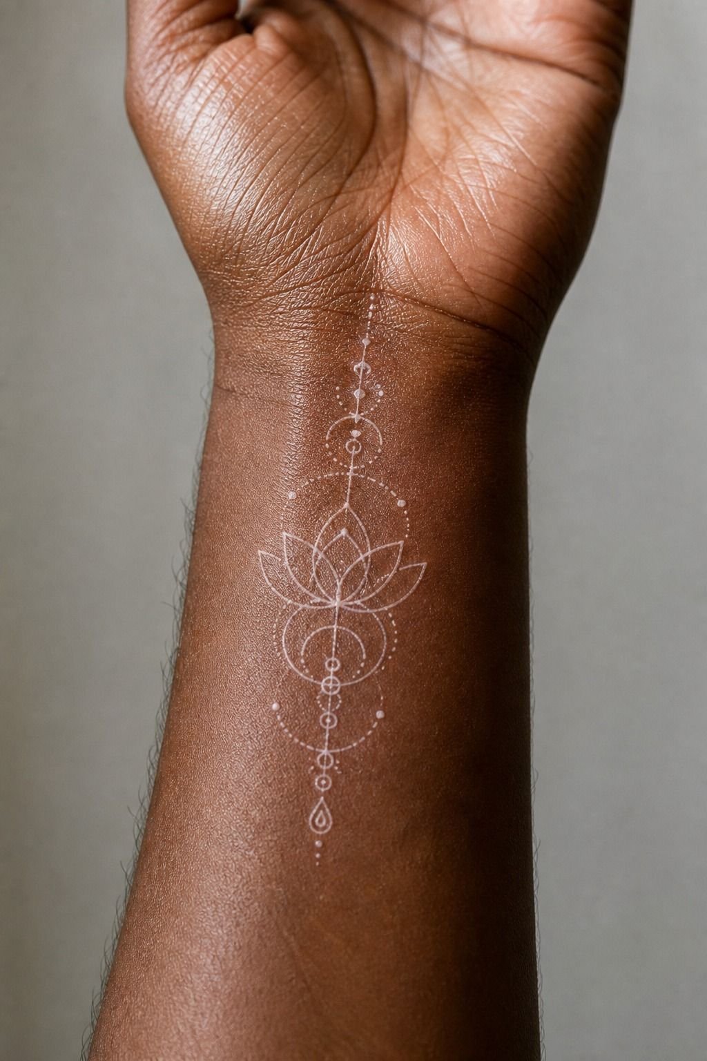 White Ink Front Wrist Symbol Tattoo