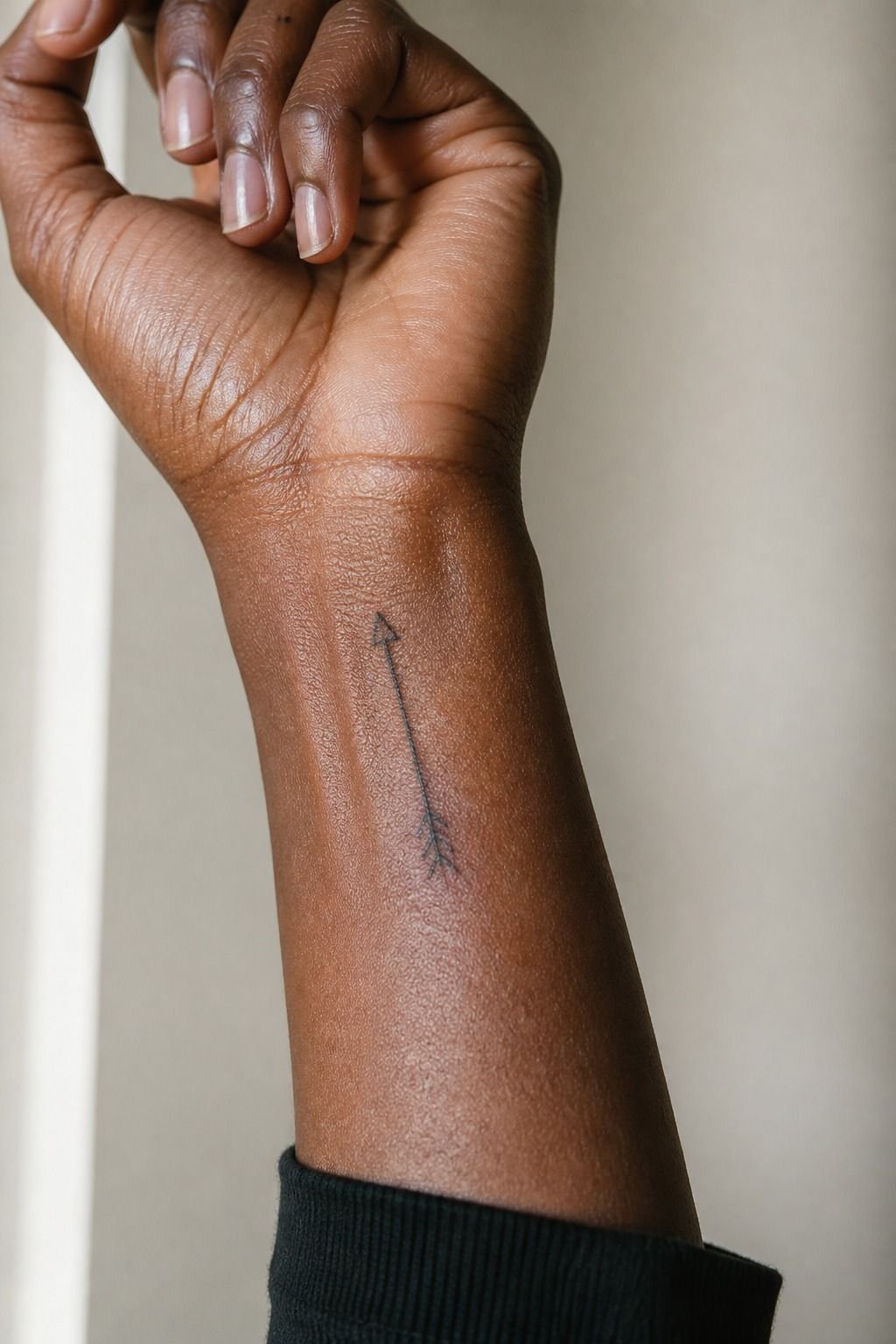 Fine-Line Arrow Front Wrist Tattoo