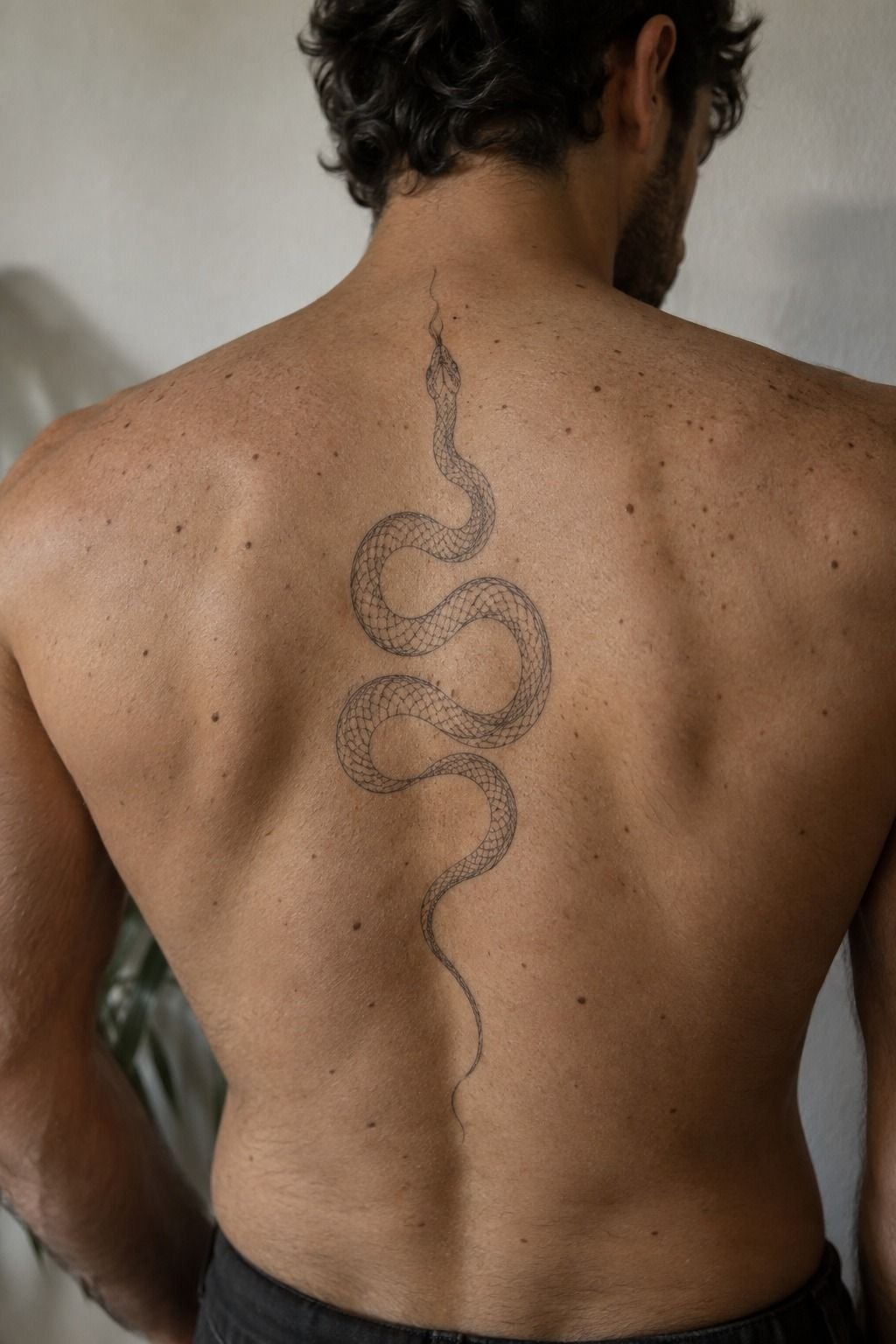 A Flowing Snake Tattoo for the Lower Back