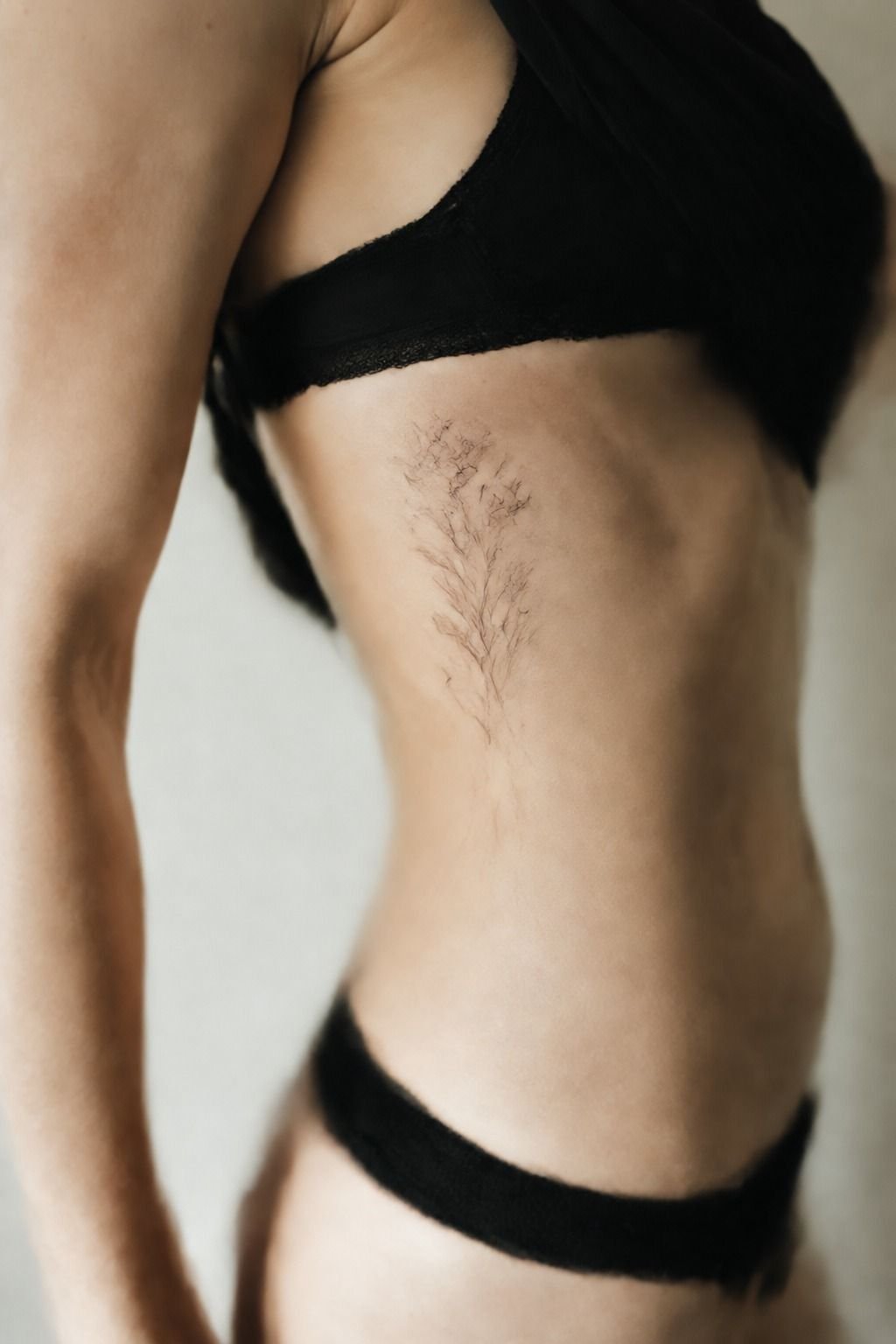 Choosing A Feminine Rib Tattoo Placement: The Rib Curve Rule