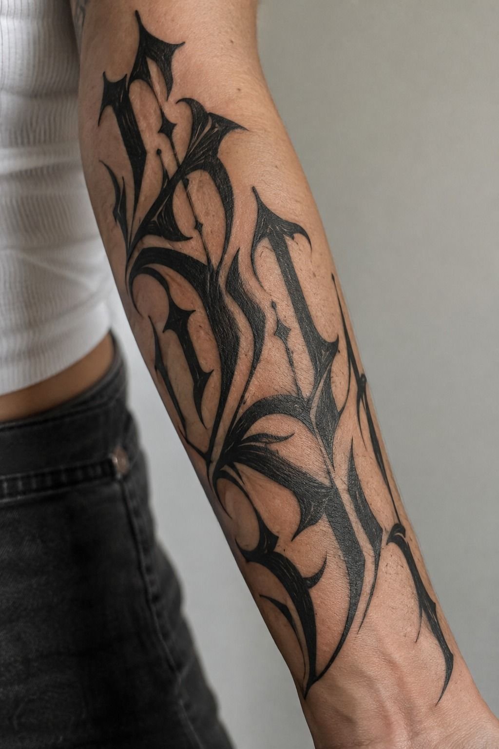 Bold Gothic Lettering Across the Forearm