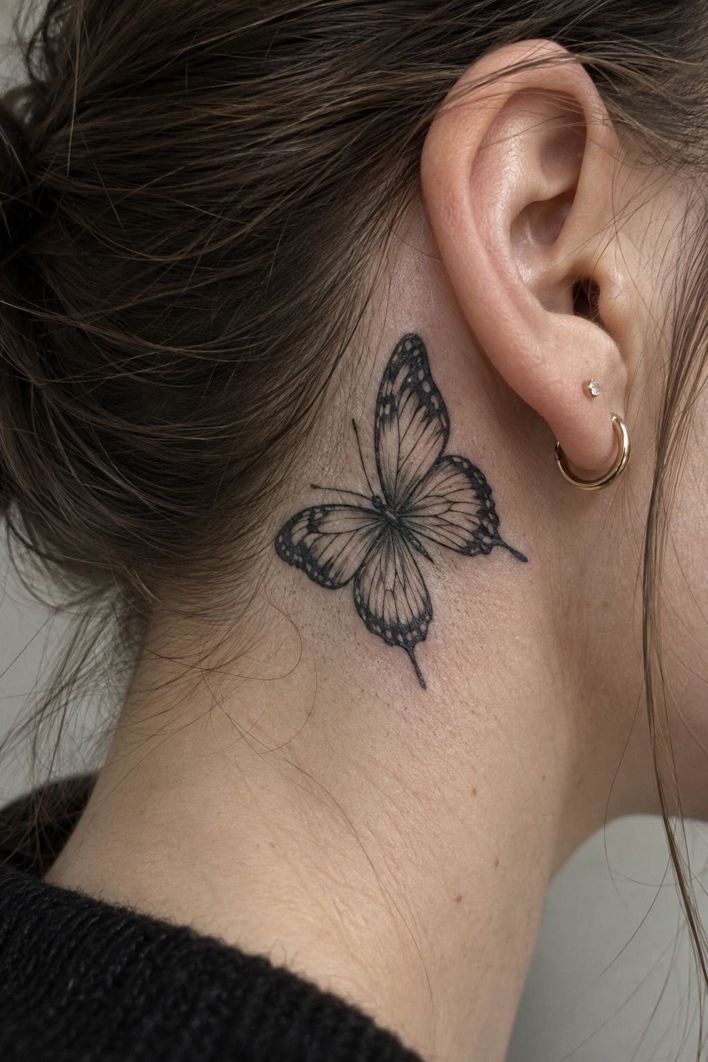 Tuck a Black Butterfly Tattoo Behind the Ear