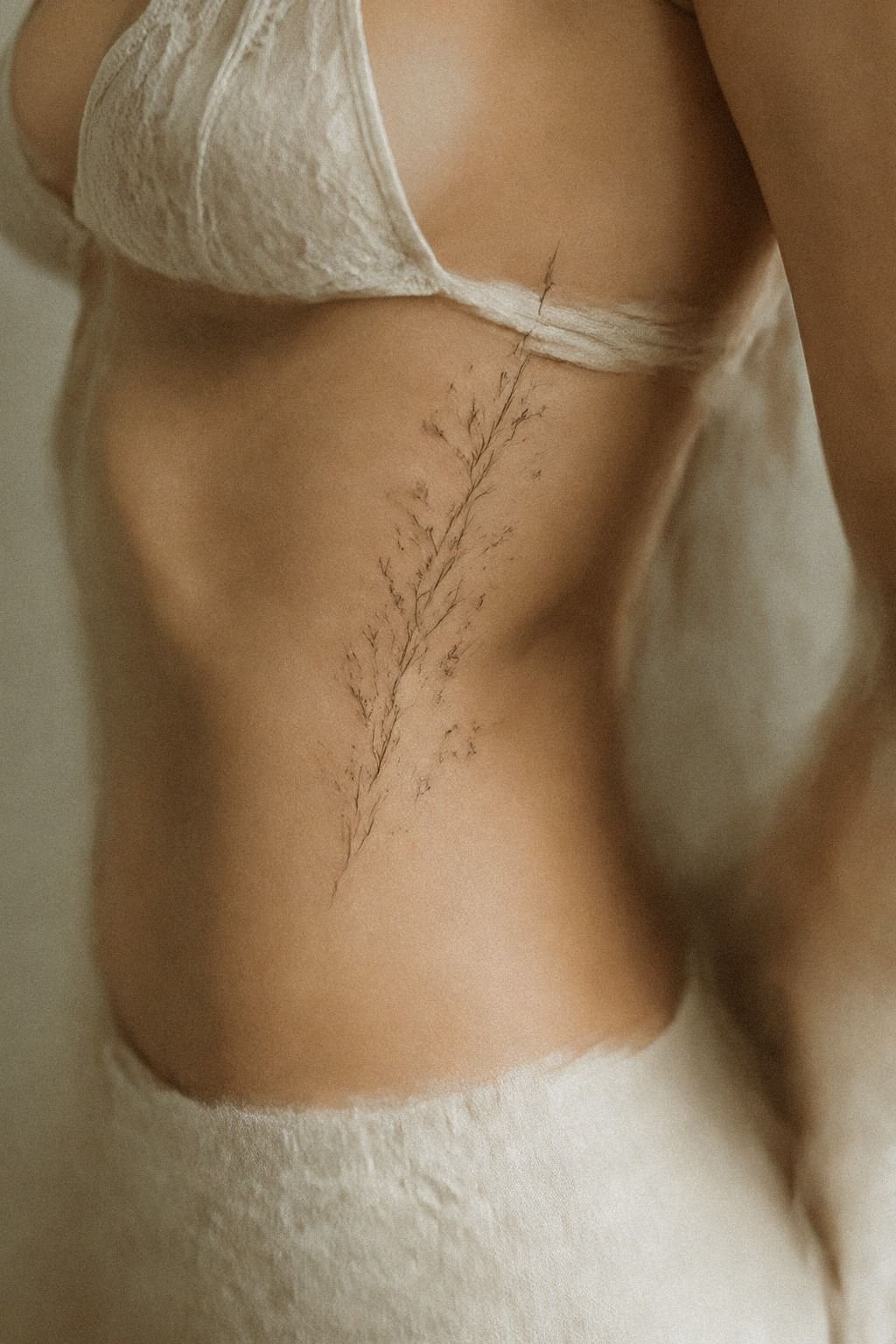Trace Minimalist Rib Tattoos Along The Curved Ribs